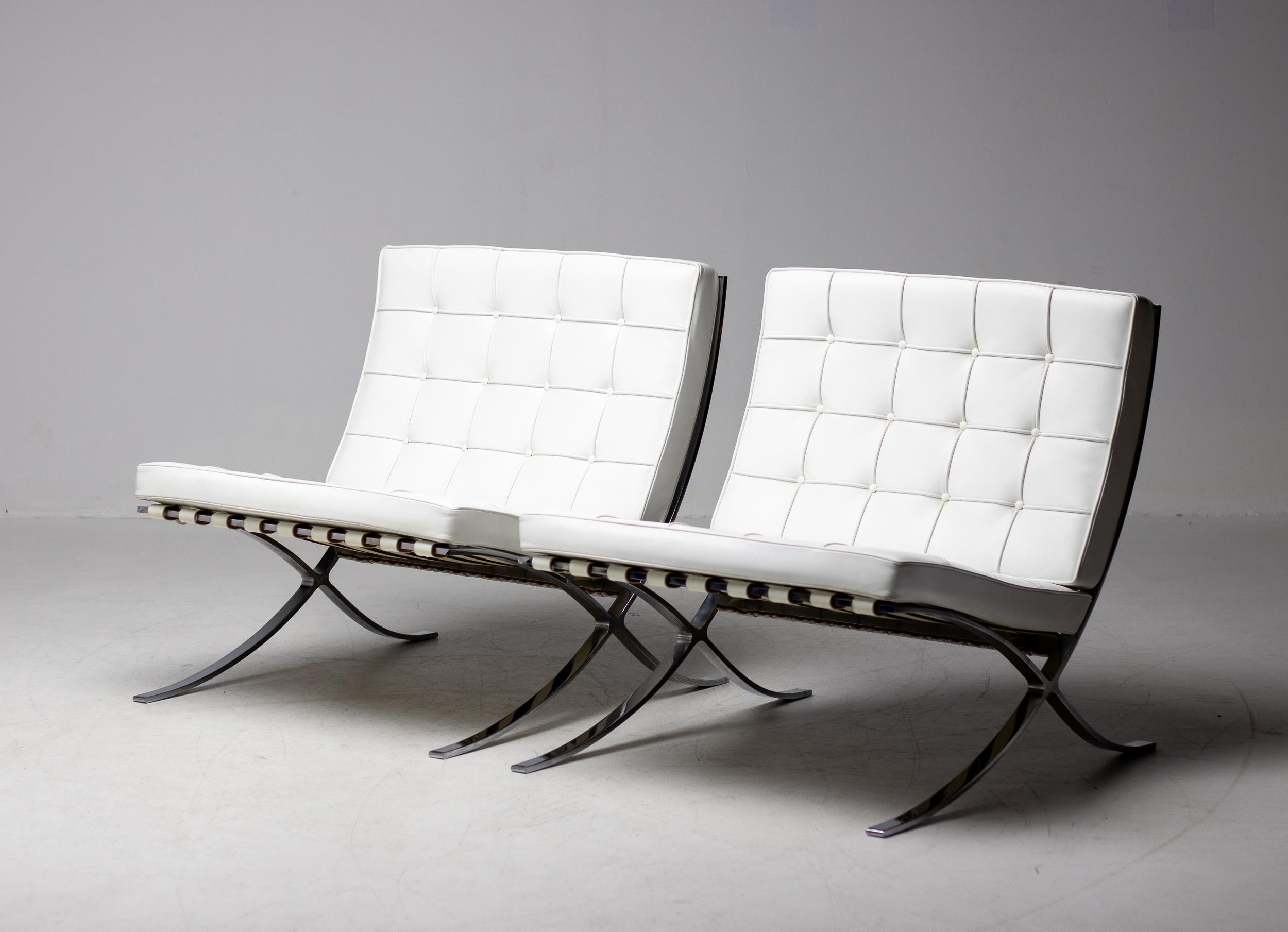 This pair of gorgeous white leather 'Barcelona' lounge chairs by Ludwig Mies van der Rohe for Knoll Studios is double-signed on each piece, with Knoll on the bottom of the seat cushions and Knoll Studio embossing with Mies van der Rohe signatures
