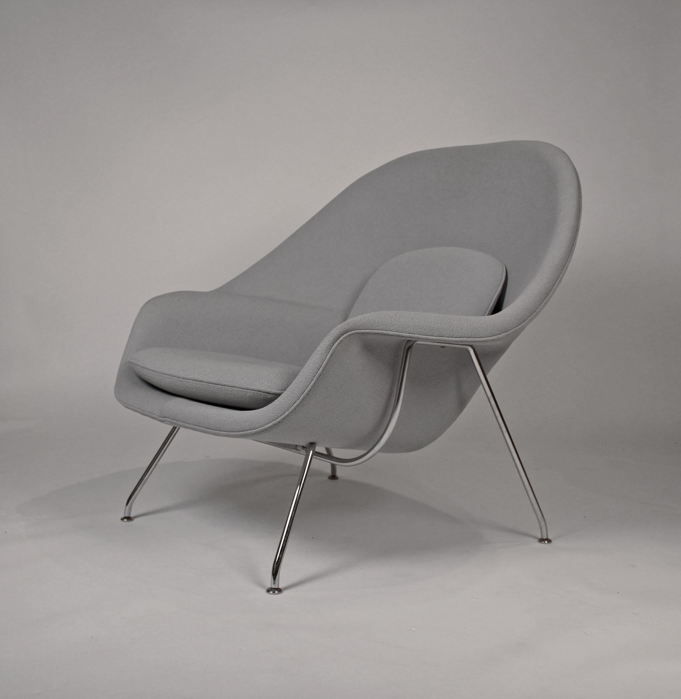 Very clean pair of womb chairs designed by Eero Saarinen and produced by Knoll. Retains paper label to underside. $3400 each. Original grey upholstery.