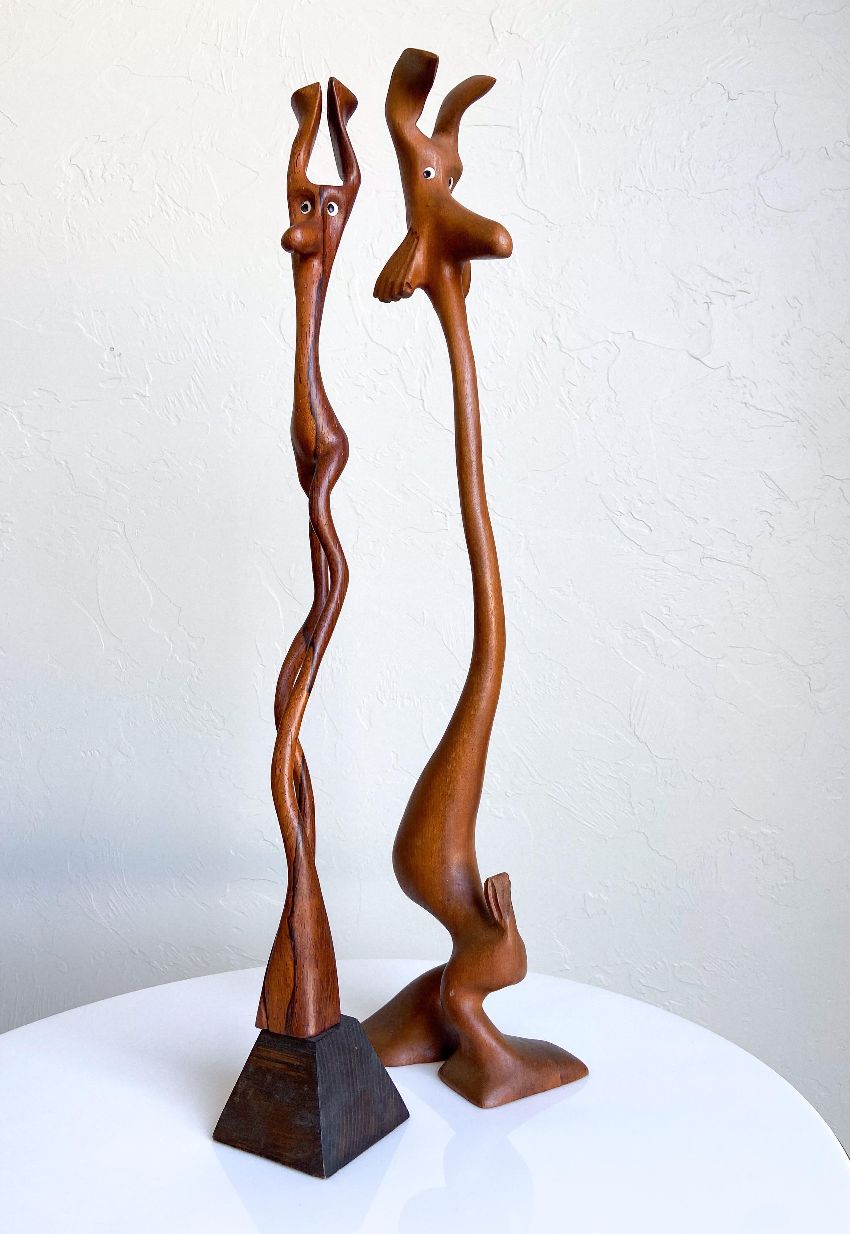 A rare pair of hand carved, organic, abstract animal sculptures by Knud Albert. Each figure is carved from a single piece of wood. All are unique and one of a kind.