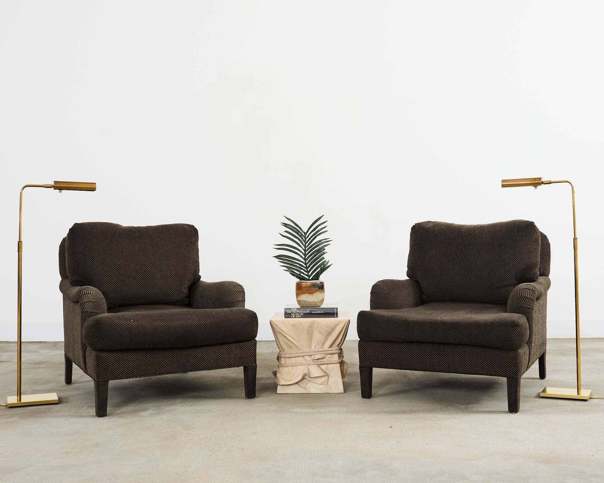 Midcentury modern pair of patinated brass pharmacy floor lamps by Koch and Lowy. The lamps feature an adjustable column that rises from 37-47 inches high. Each lamp has an adjustable head with a dimmer switch. The shades have a classic round tube
