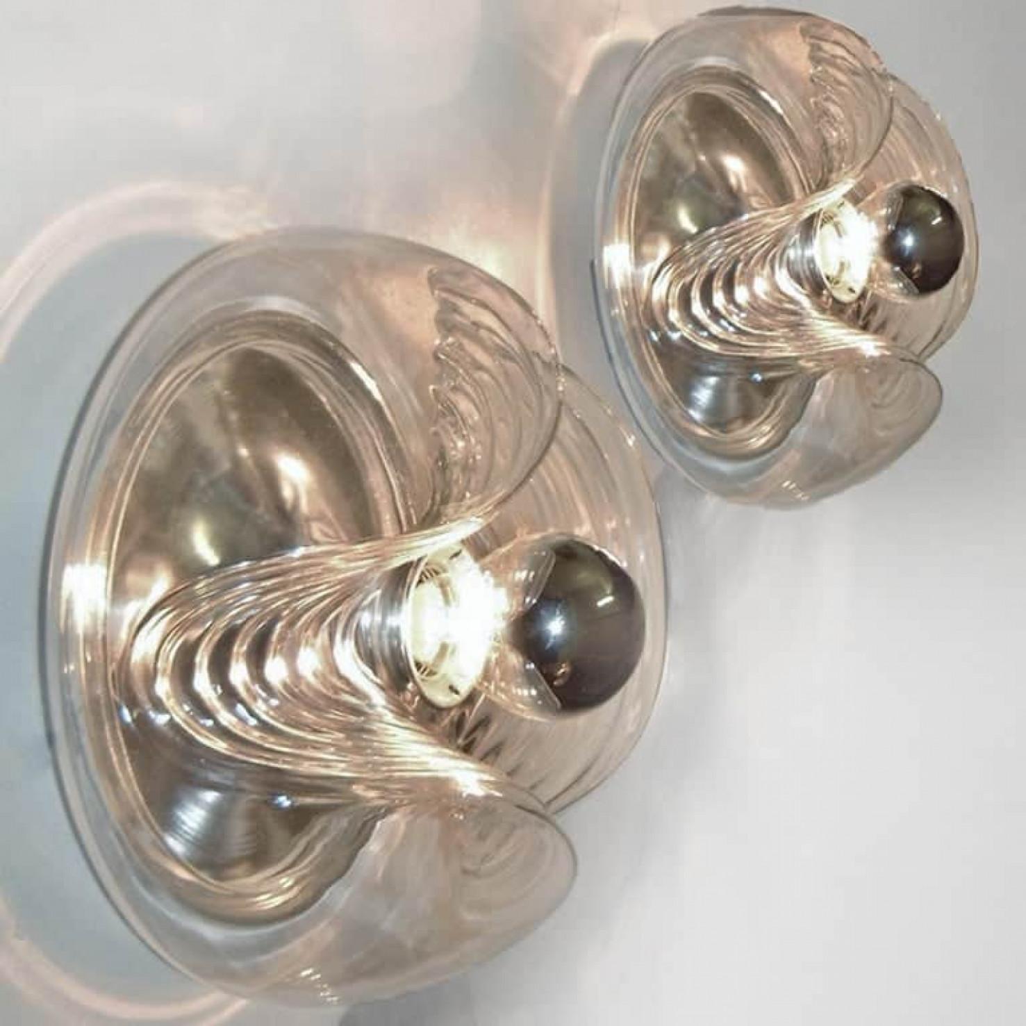 Pair of mid-20th century flush mount or wall sconces designed by Koch & Lowy for Peill & Putzler in the 1970s. Featuring a clear glass globe shade with a waved or ribbed molded bubble form, casting a stunning rippled light across a wall or ceiling.