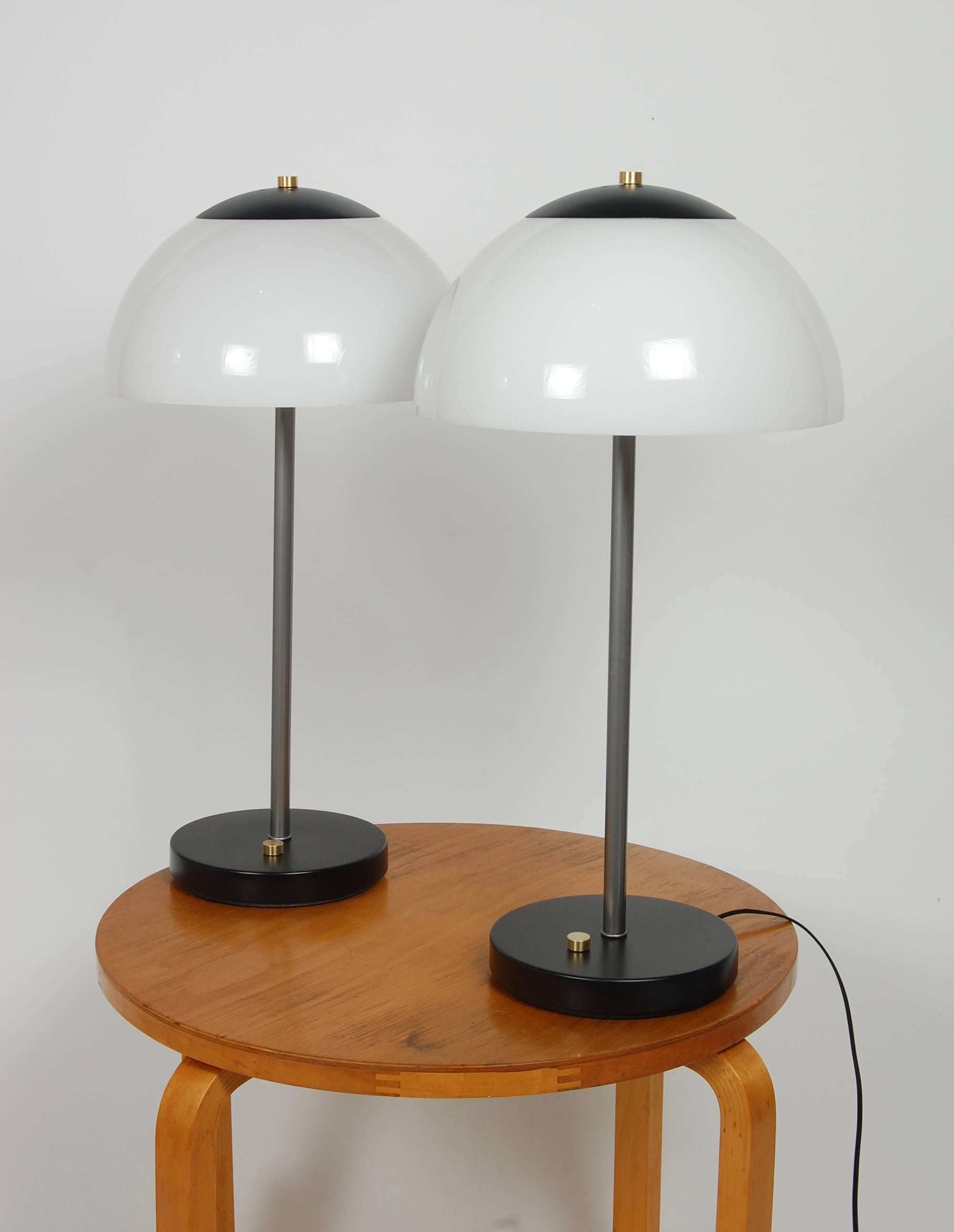 Pair of table lamps by Koch & Lowy, half glass dome shade that tilts to adjust the light. Two light sockets per lamp. Brass accents on the top of shade and switch on base.