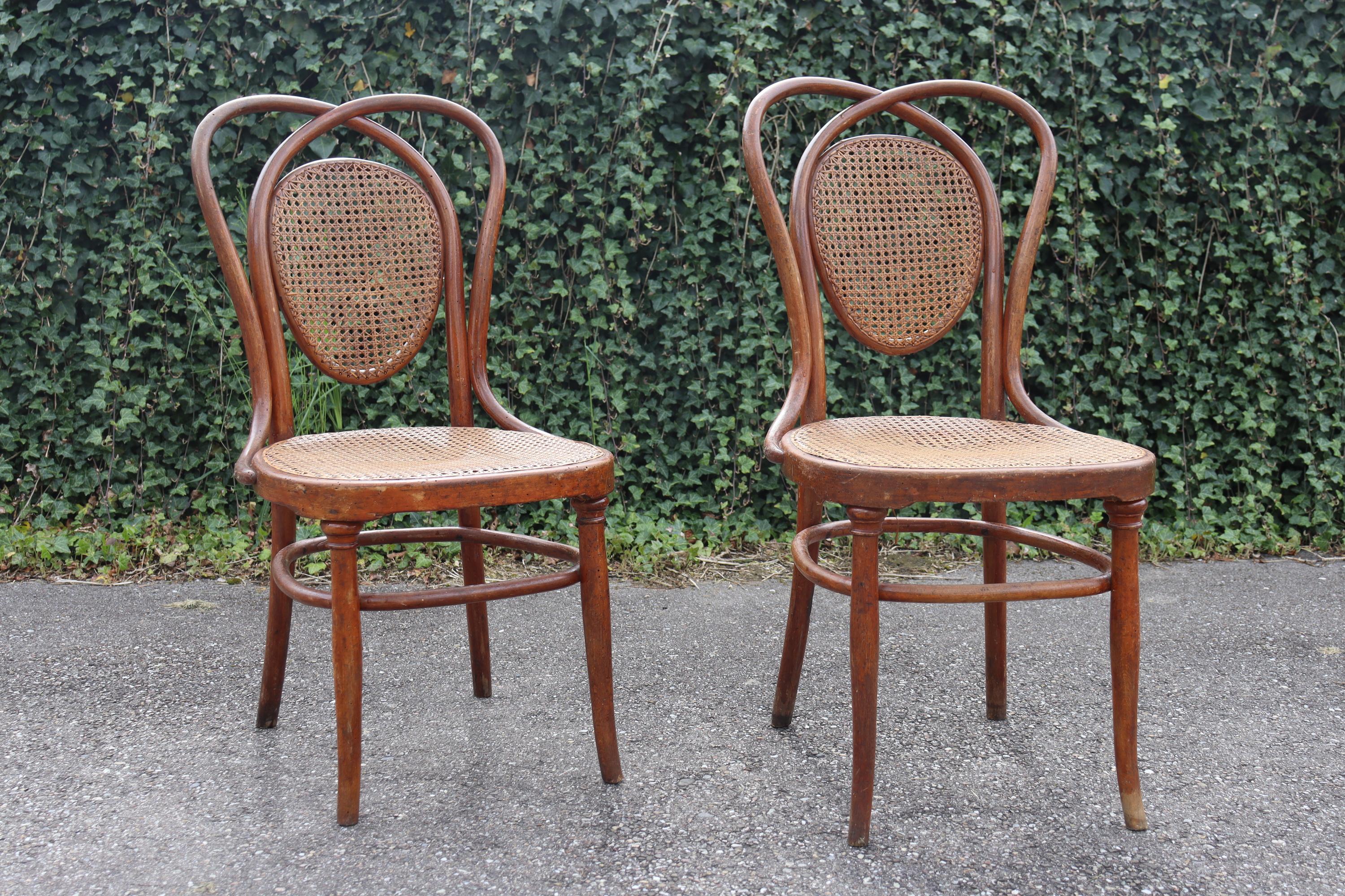 Pair of Viennese chairs made by Jacob & Joseph Kohn, model no. 33 from the 1884 catalog. Wsetin Manufacture. High-end chair model for the period. Frame in light brown bent beech. Seat and back with canework in good used condition. Stamped with label
