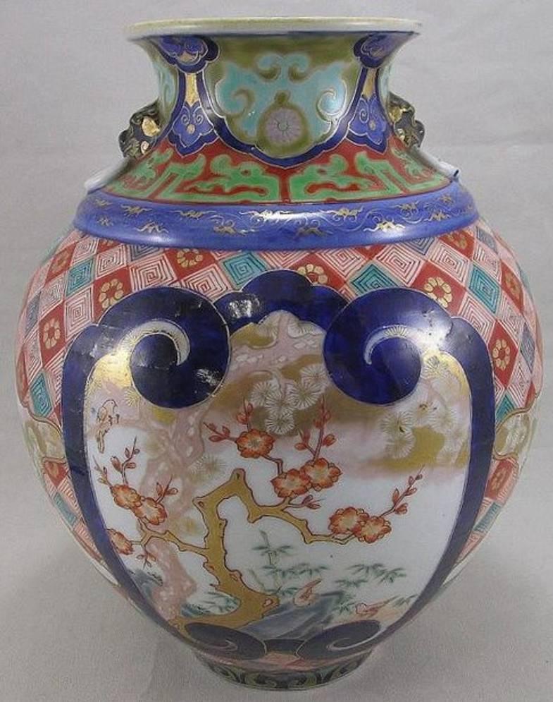 Extraordinary rare Japanese Meiji Period pair of gilded and hand painted porcelain vases in vivid green, red, blue and pink on a stunningly shaped fine porcelain body. The mark depicts the Koransha orchid in red and is signed “Fukugawa Sei”