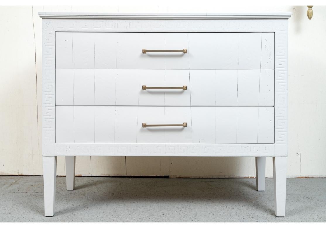Pair of fine quality light grey paint decorated wood credenzas with three deep and easy glide drawers with gold-tone hardware and resting on slightly tapering legs. The credenza decorated with Greek key design around cabinet.

Dimensions: 49