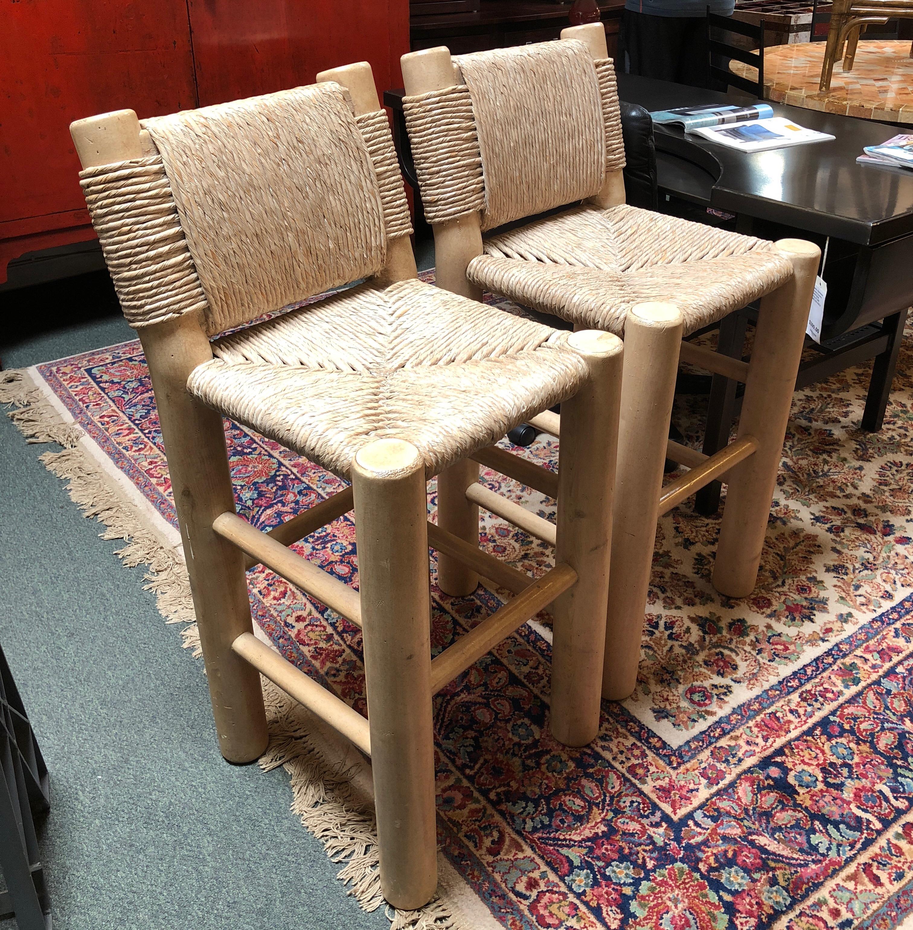 A pair of barstools, by Kreiss. Solidly built, the rush wrapped barstools have a whitewashed finish. Perfect for counter or tiki bar (indoor).