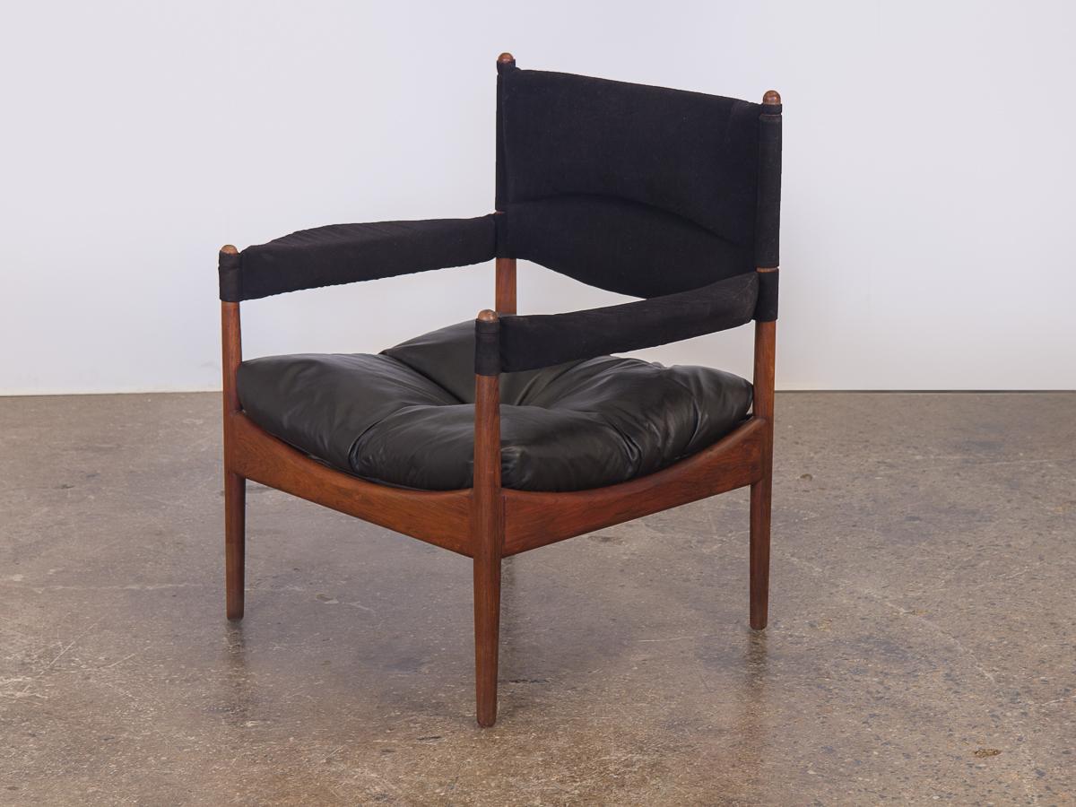 Pair of Kristian Vedel Modus lounge chairs. The sling-like sculpted back and armrests form to the body. Gorgeous Brazilian rosewood frames are in excellent condition with a striking grain pattern throughout. Top is upholstered in a felt fabric, and