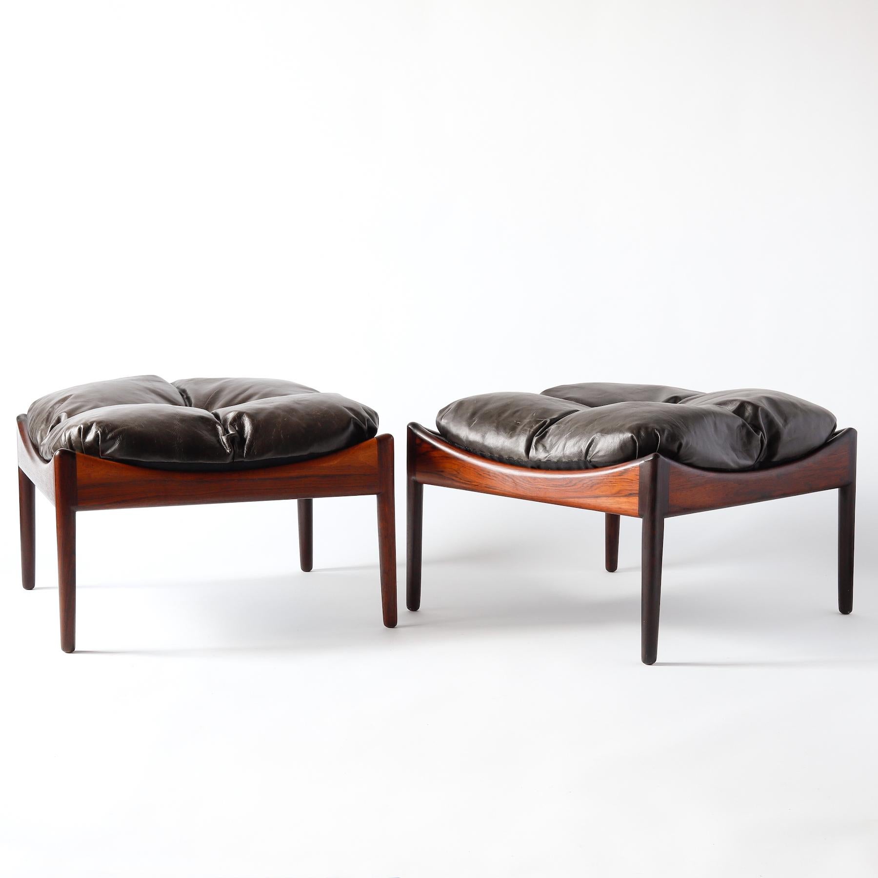 Pair of rosewood ottomans with leather cushions designed by Kristian Vedel for Soren Willadsen of Denmark. These ottomans were part of Vedel's Modus line from the 1960s, which included a lounge chair and side table that used the same rosewood frame.