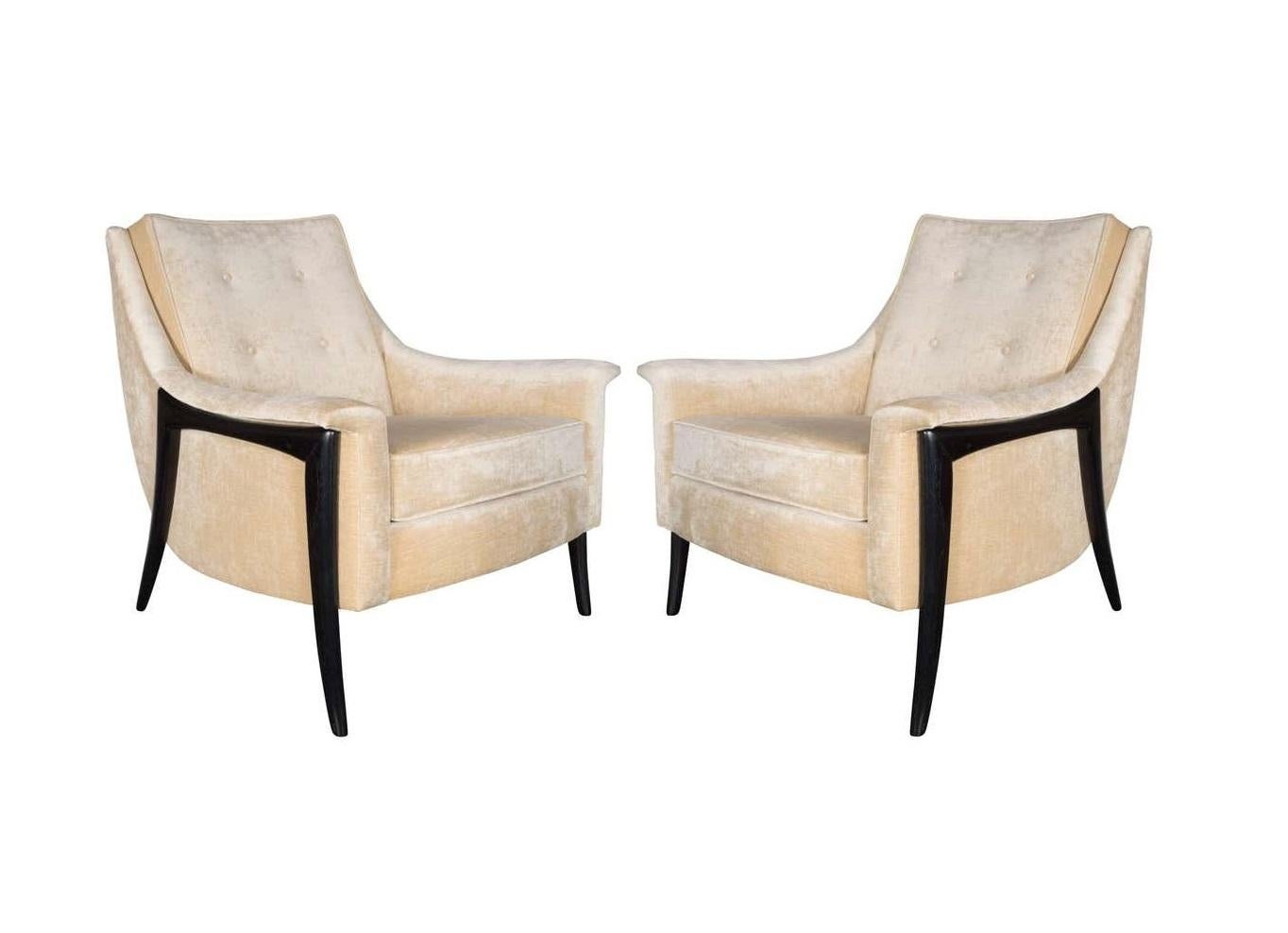 This stunning pair by Kroehler Avant Designs. Featuring sleek curved backs, leading to padded arms with a removable seat cushions all rising on sculptural form splayed legs. The legs are made of walnut and have a nice ebonized finish that