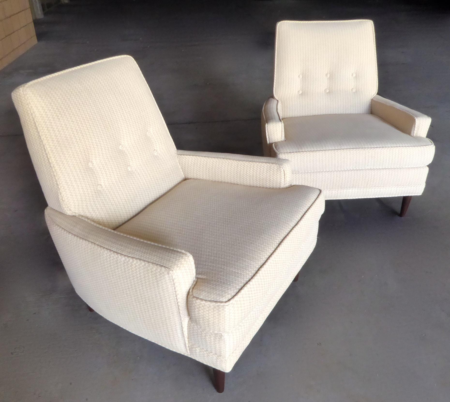 A pair of upholstered armchairs with conical walnut legs, designed by Valentine Seaver and made by the Kroehler Manufacturing Company, circa 1960. An original label is present which identifies the designer and date of order (1-21-60).
The chairs
