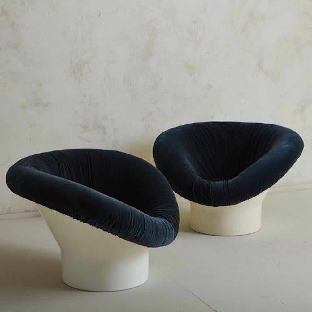 A pair of Krokus lounge chairs by Swedish designer Lennart Bender for Ulferts AB in the 1960s. These statement chairs feature molded white fiberglass bases with dramatically curved seats  in original navy blue velvet with ruched detailing. Unmarked.