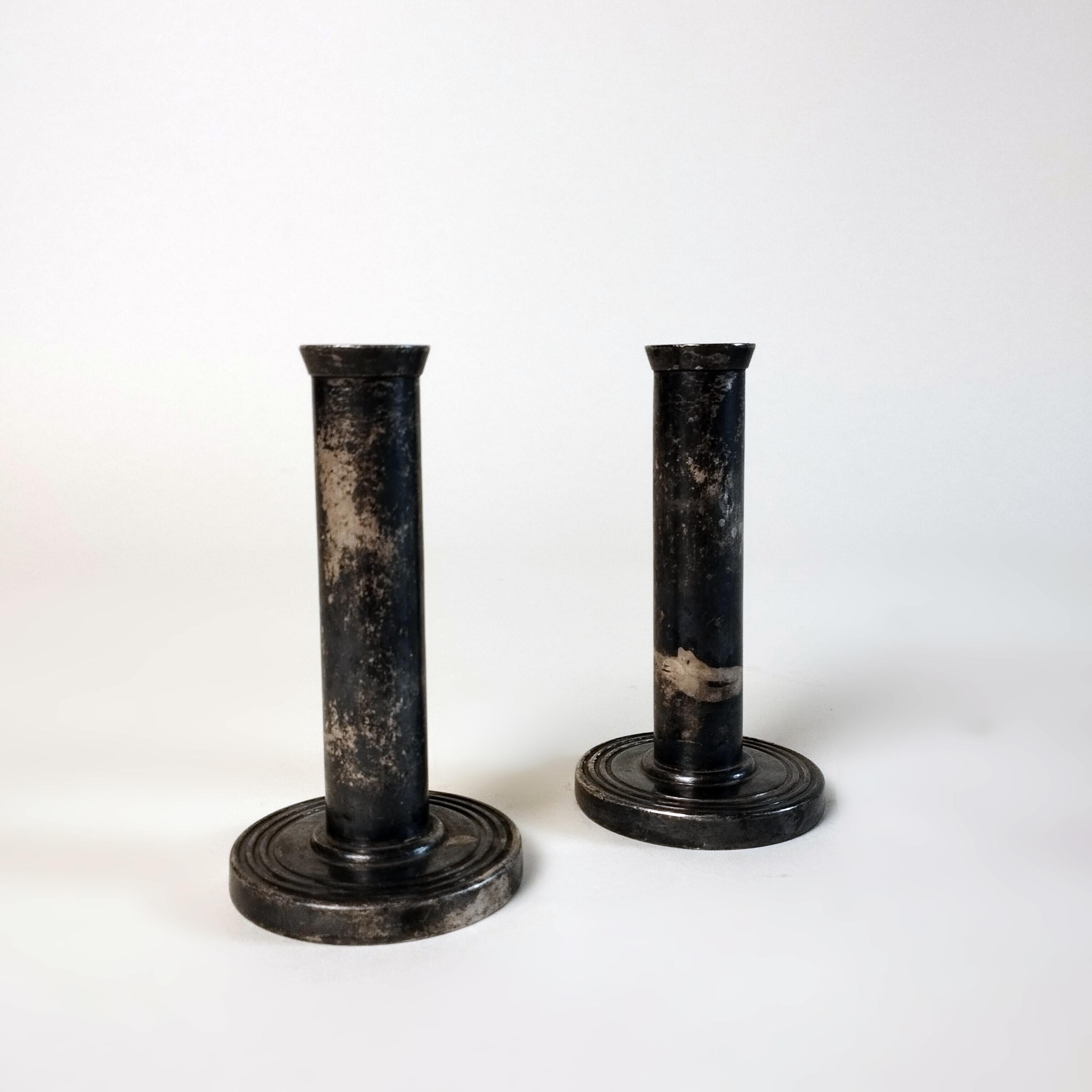A pair of silverplate candlesticks in the style of Gio Ponti by Krupp Milano. The sticks have a flat cylindric design over a round fluted base. Sealed on the base.

The pair of candlesticks in being offered as is, with the stains of dirt on the