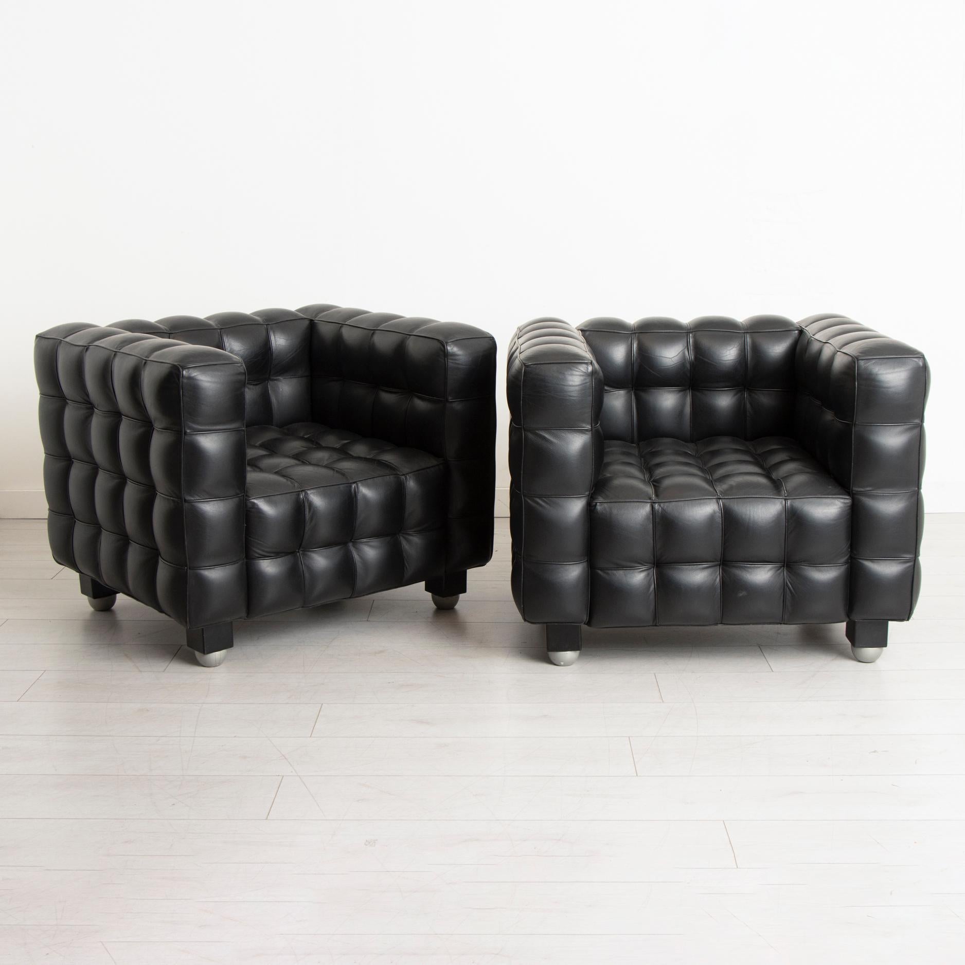 A pair of Kubus black leather armchairs in the manner of Josef Hoffmann circa 1970s. Originally designed by Josef Hoffman in 1910. Very good condition.