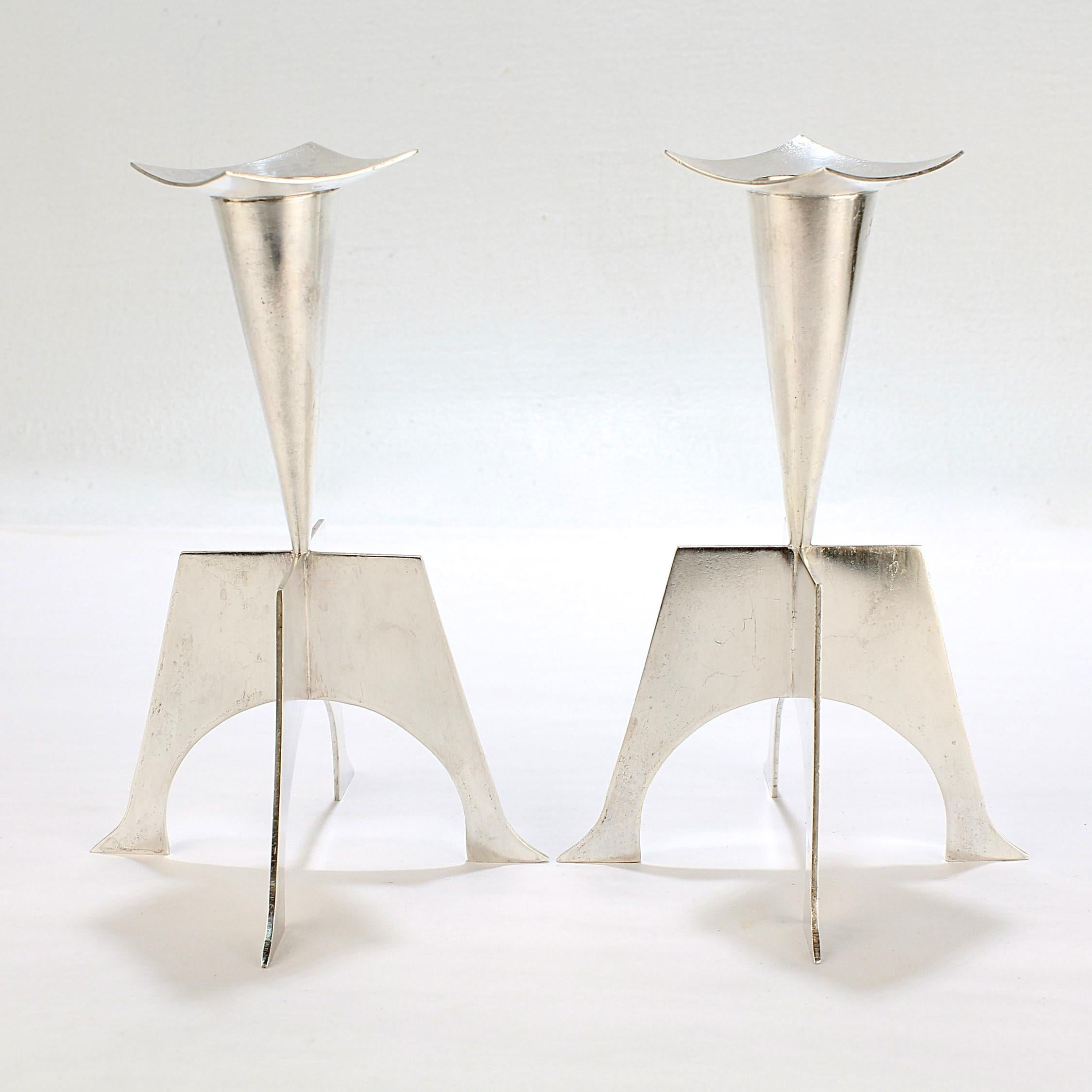 A fine pair of modernist sterling silver candlesticks.

Handmade by the renowned silversmith Kurt Matzdorf.

The surface of the silver shows a varied texture almost like a variegation. It's quite possibly Matzdorf smelted the silver alloy and made