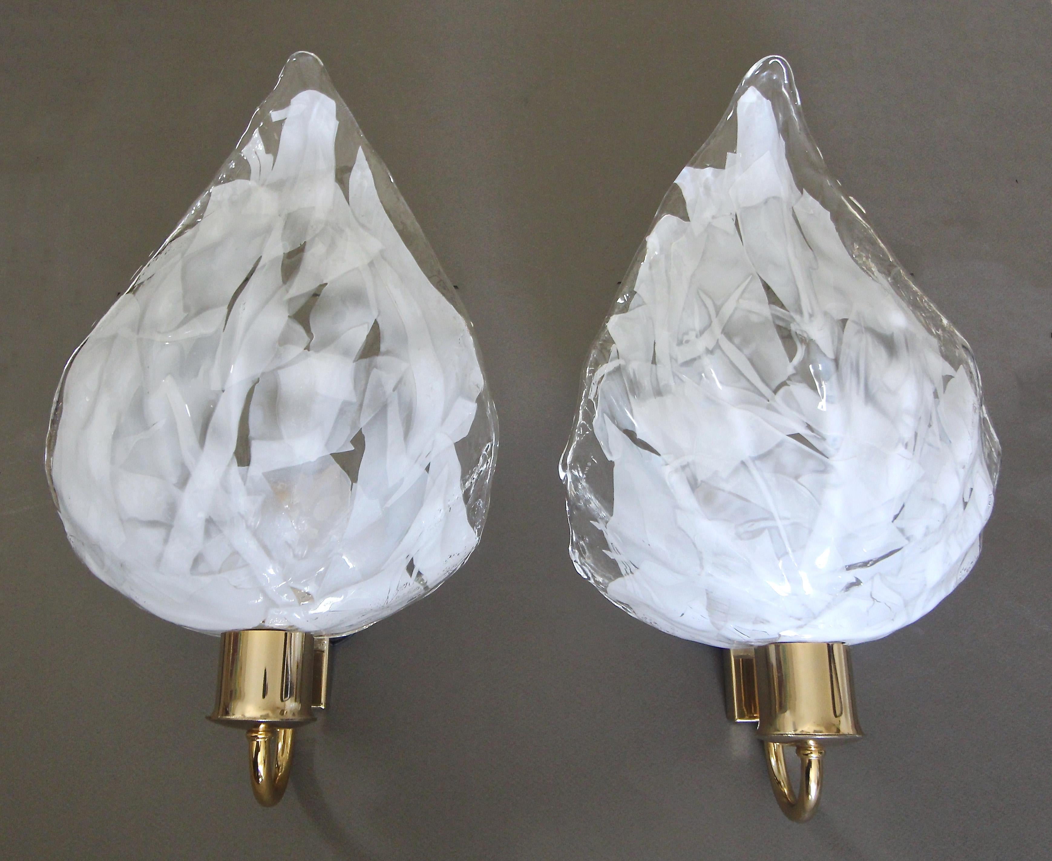 Pair of La Murrina Italian handblown clear and white leaf shaped wall sconces mounted on brass wall plates. Newly wired for the US. Each uses a single A or Edison base bulb. (White junction box cover included, see photo.) 

Measures:
Glass alone