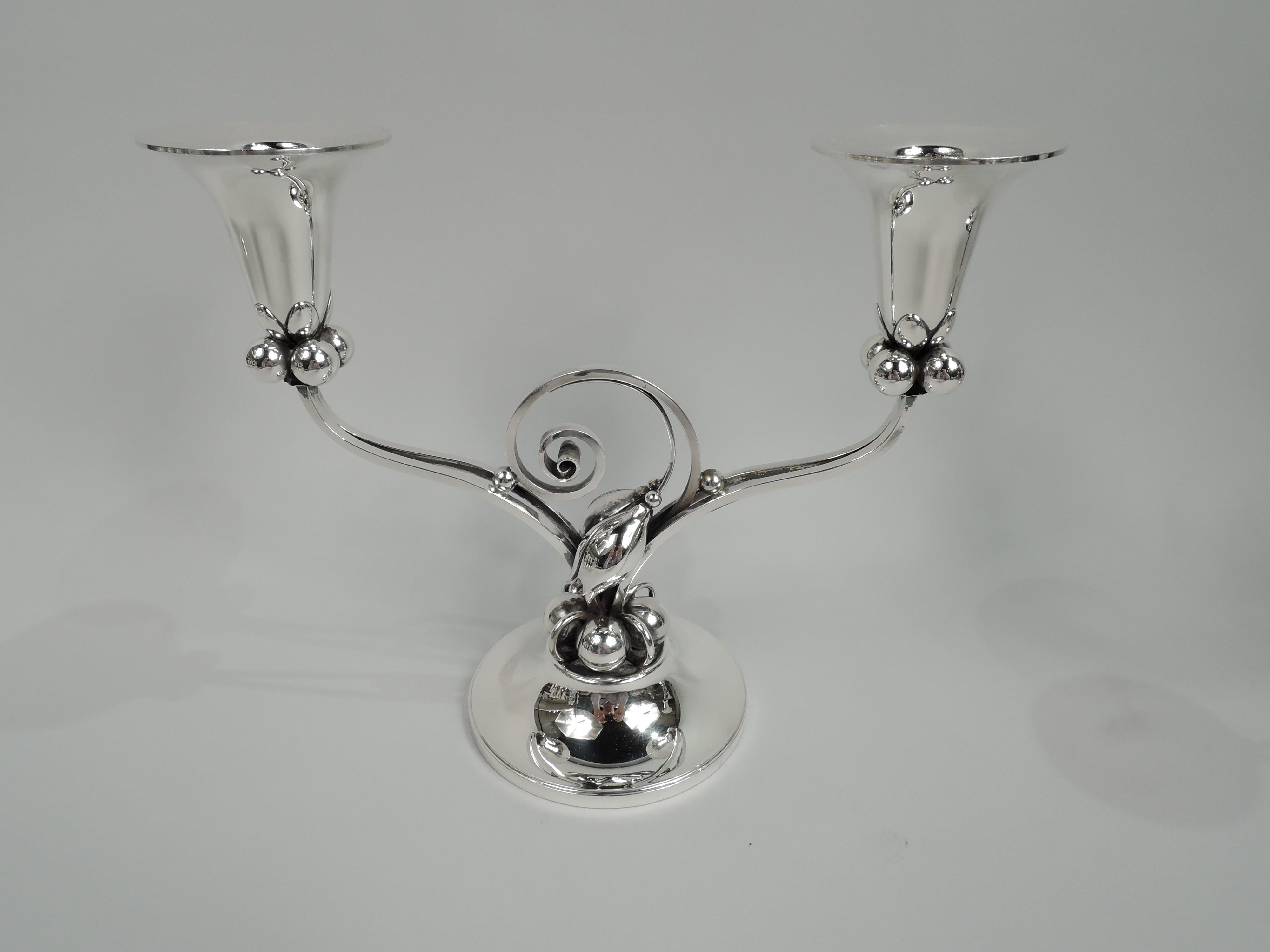 Pair of Mid-Century Modern sterling silver 2-light candelabra. Designed by Alphonse La Paglia (d. 1953) for International Silver Co. in Meriden, Conn. Two arms, each comprising two open quadrilateral scrolls inset at center with volute scroll