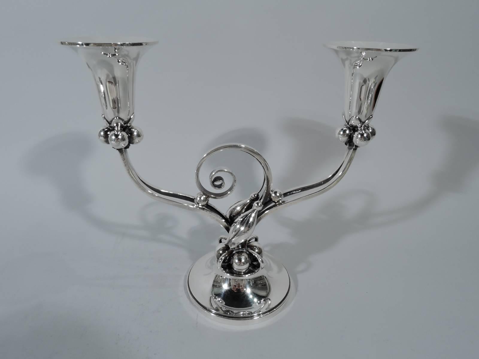 Pair of Mid-Century Modern sterling silver two-light candelabra. Made by Durham in New York. Each: Two split branches each terminating in single socket with bold beads and applied leaves at base. Raised foot with alternating beads and rings. Mounted