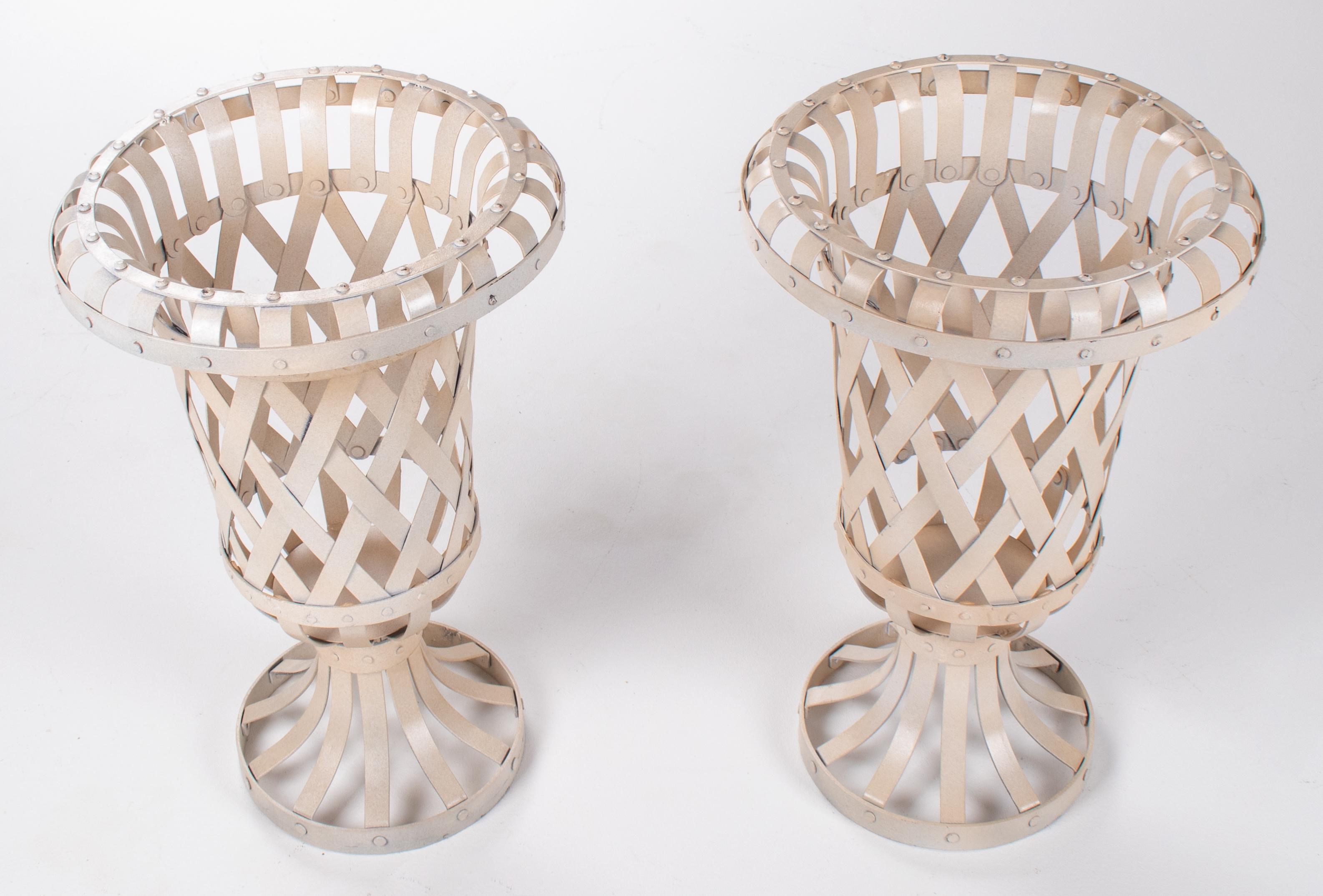 Pair of laced iron white garden urns.