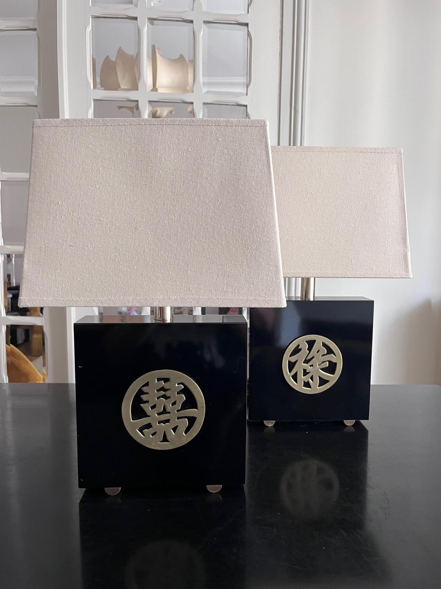 Beautiful lamps from the 1970's in lacquer, chinese ideograms in brass, brass patins. 
Design Jean Claude Mahey for Maison Romeo 
Original wire, new shades.