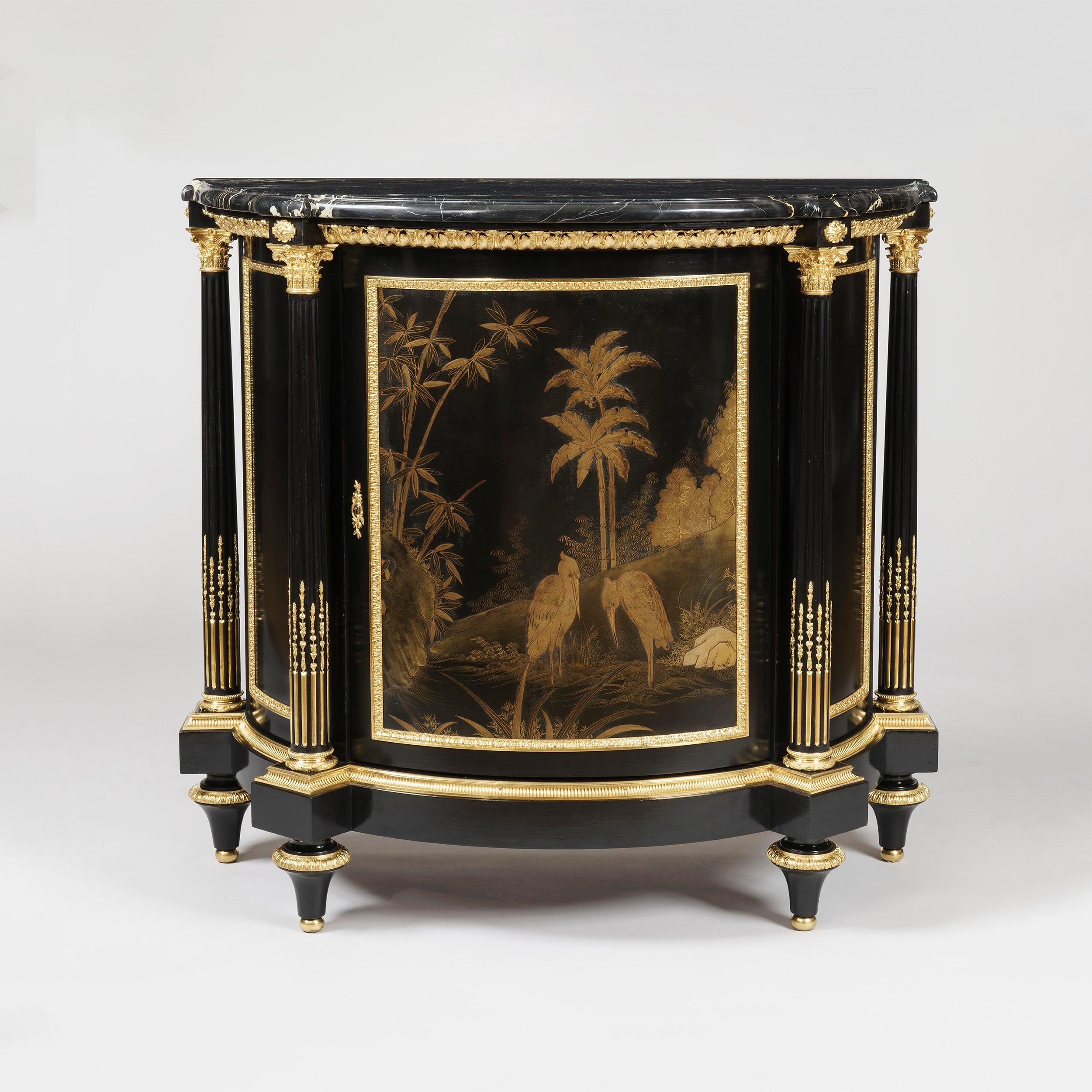 A pair of cabinets in the Louis XVI manner
By Maison Millet of Paris

The pair of demilune cabinets constructed from bois noirci, rising from tapering toupie feet, the curved front inset with fine imported Japanese lacquer panels and flanking