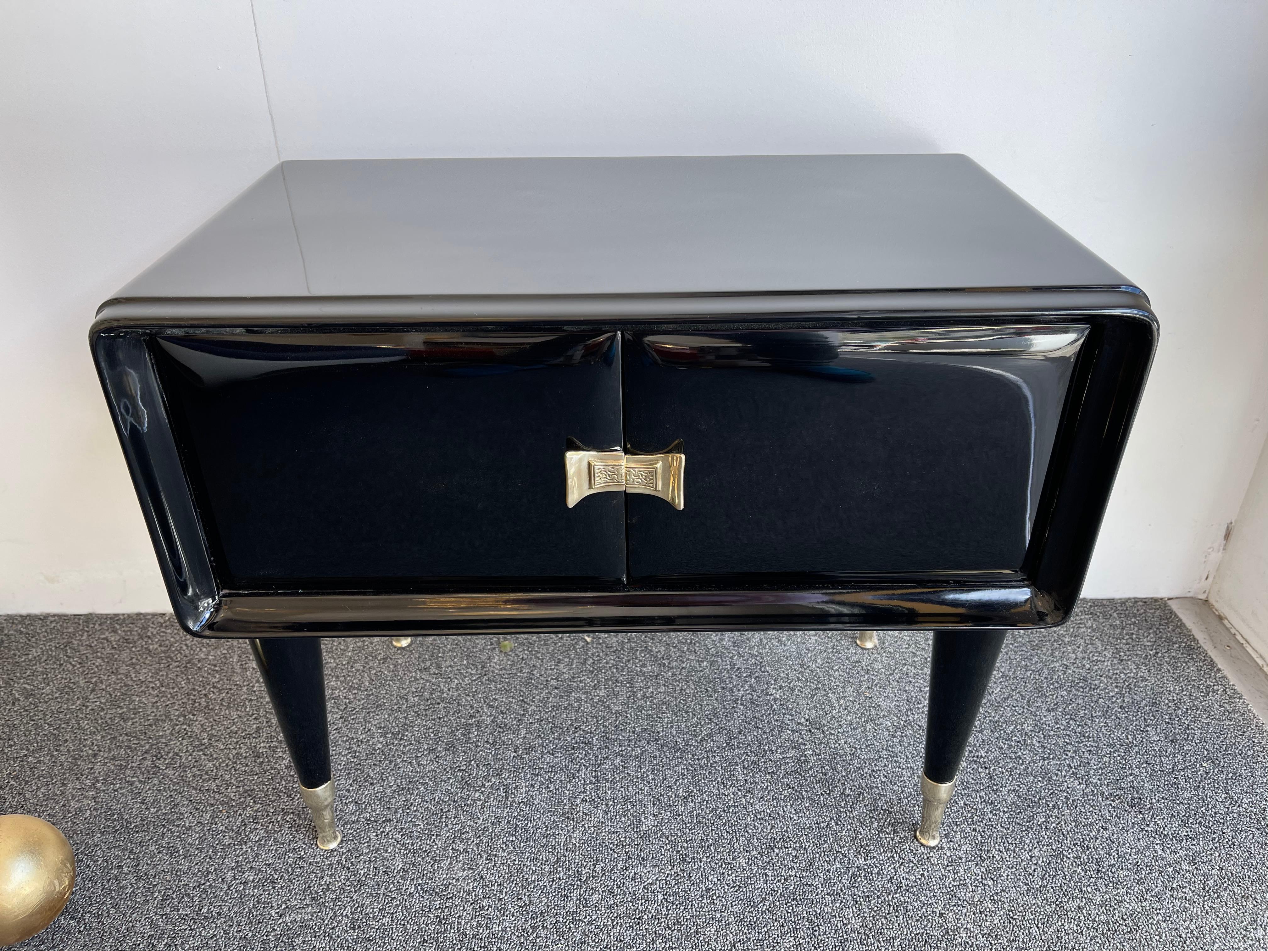 Pair of black lacquered wood nightstands, side end low tables, brass feet and handle. Also available the sideboard buffet credenza or large commode chest of drawers. Famous design like Gio Ponti, Ico Parisi.