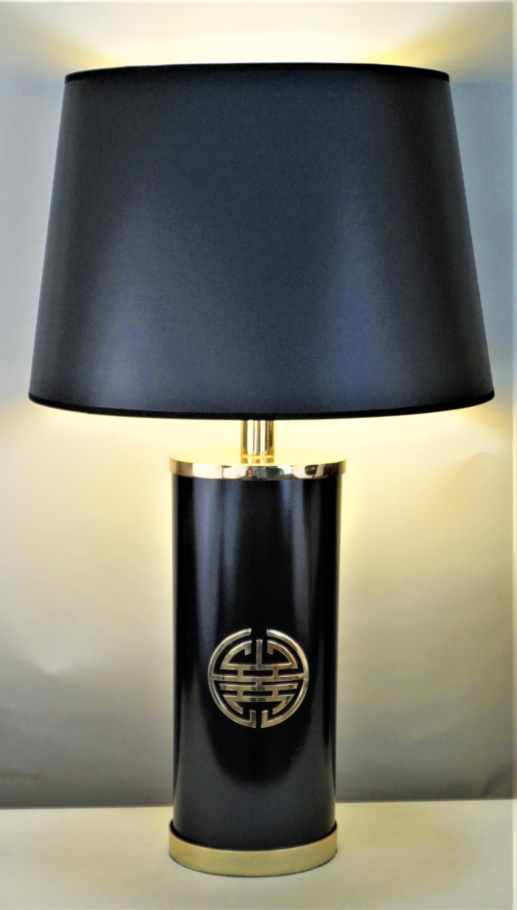 Pair of oval shape black lacquered and brass table lamps with Chinese character fitted with black gold liner lampshade.
Measurement include the lampshade.
12