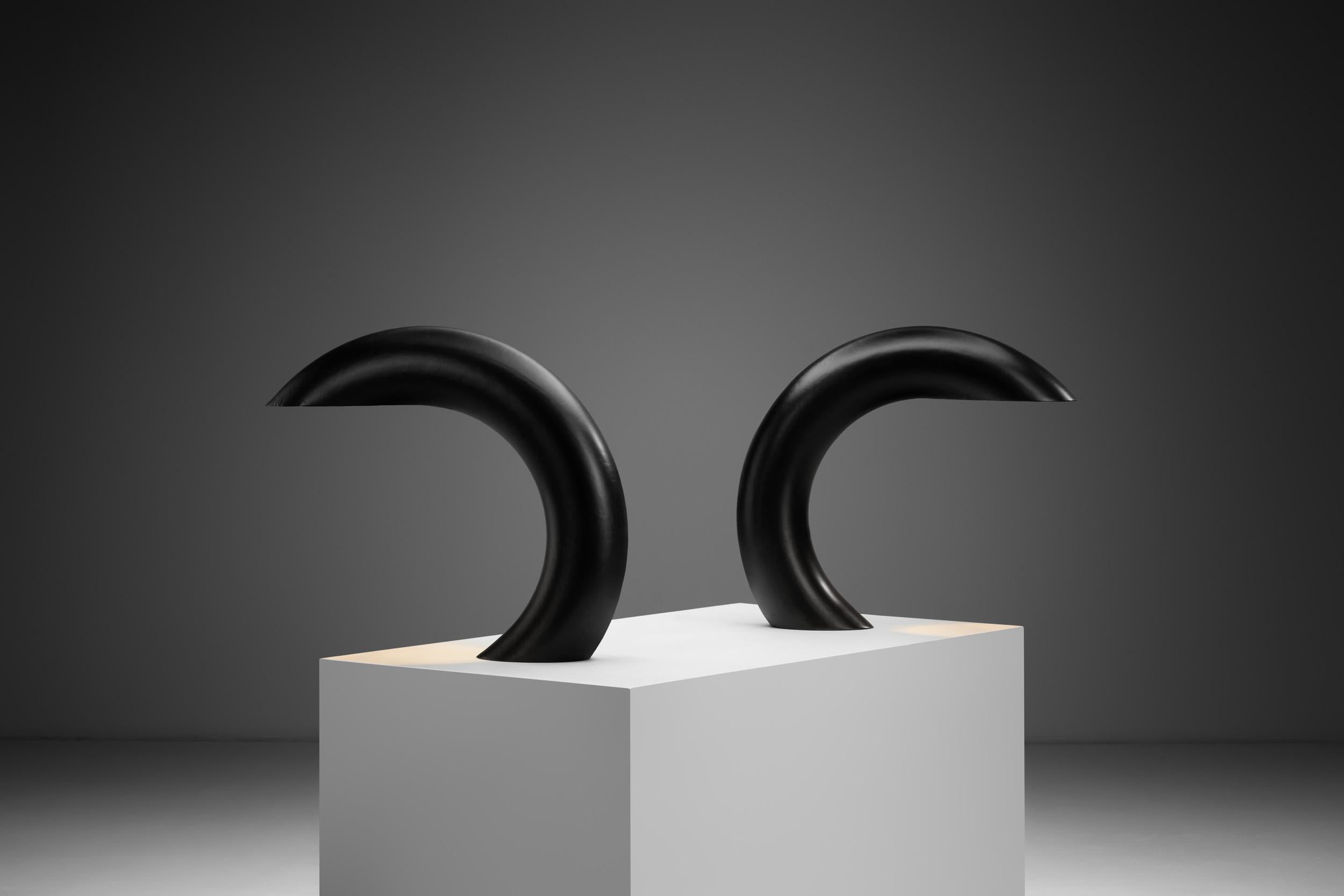 This pair of sculptural table lamps was designed in Italy by a little-known company named Alfredo Bianchi. As design pieces, they represent an organic mix of aesthetics and functionality.

The lamps feature a dramatic, sculpted form that blurs the