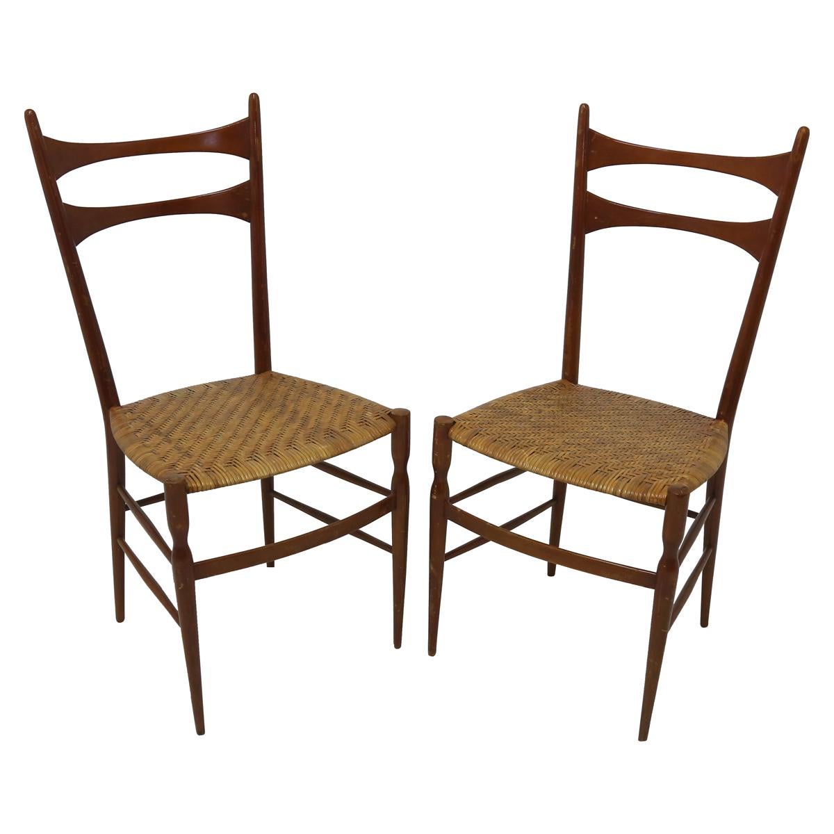 Elegant pair of Italian honey toned wood ladder back with woven rattan seats in the manner of Gio Ponti.
 