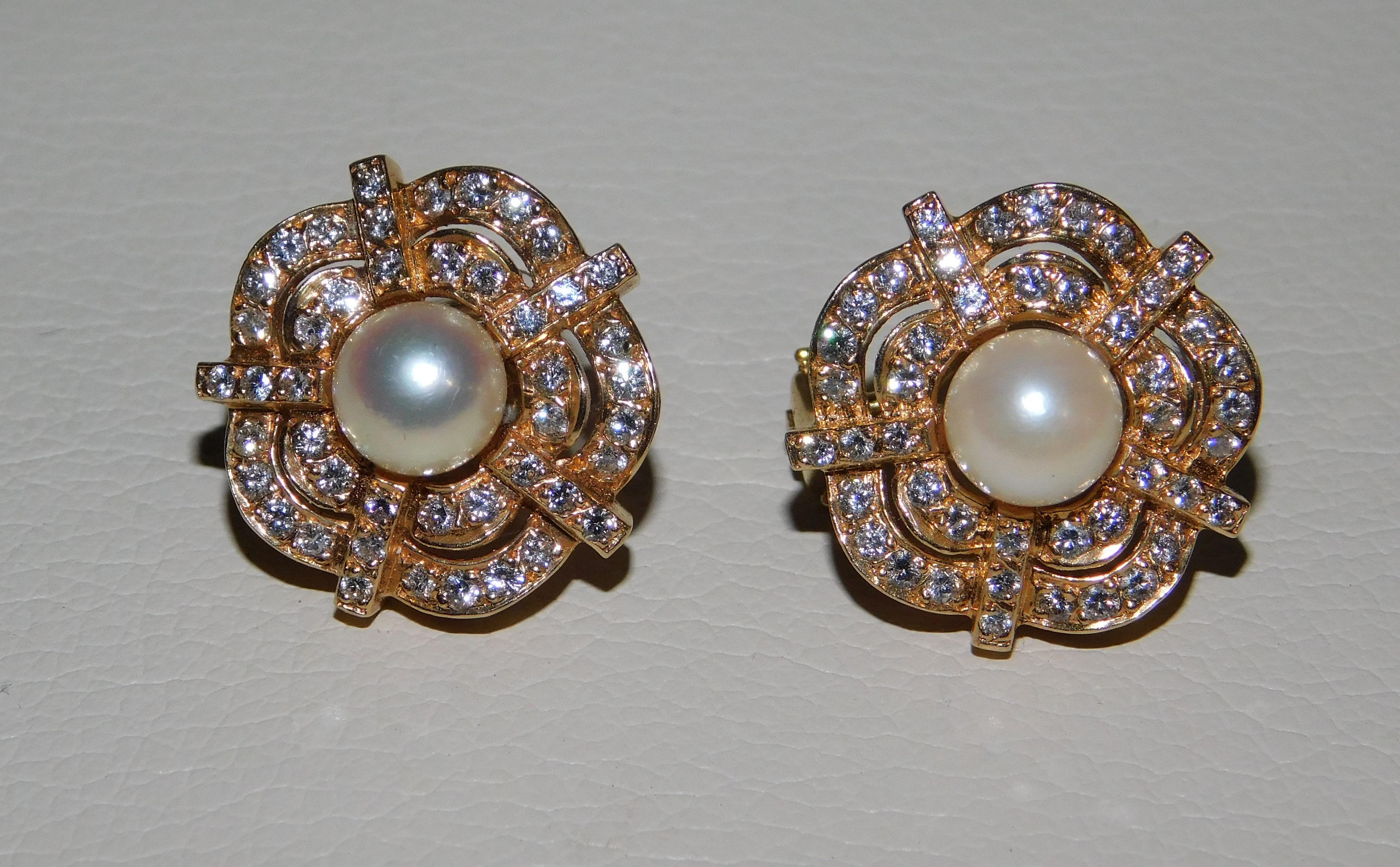 Pair of 14kt pearl earrings is set with two cultured pearls measuring approximately 7.0-7.15mm creamy colour with silvery creamy overtones.  The pearls have medium luster and medium color distribution with no apparent blemishes.  The earrings are