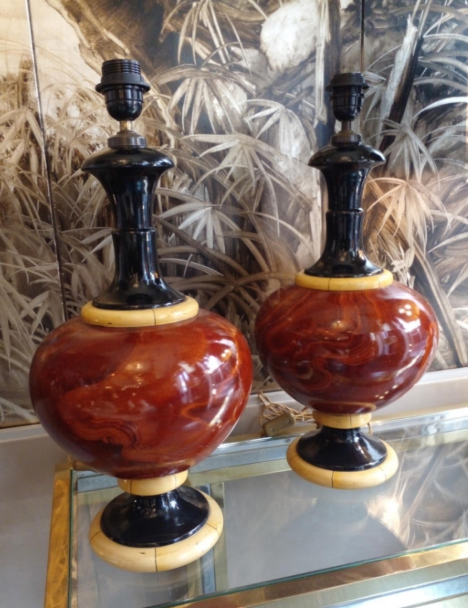 Two table lamps in ceramic painted in trompe l'oeil of marble, ivory and blackened wood. Signed under the base.

Founded in 1947, the House of Jean Roger is known throughout the world for its exquisite and original ceramics. Its founder, Jean, was