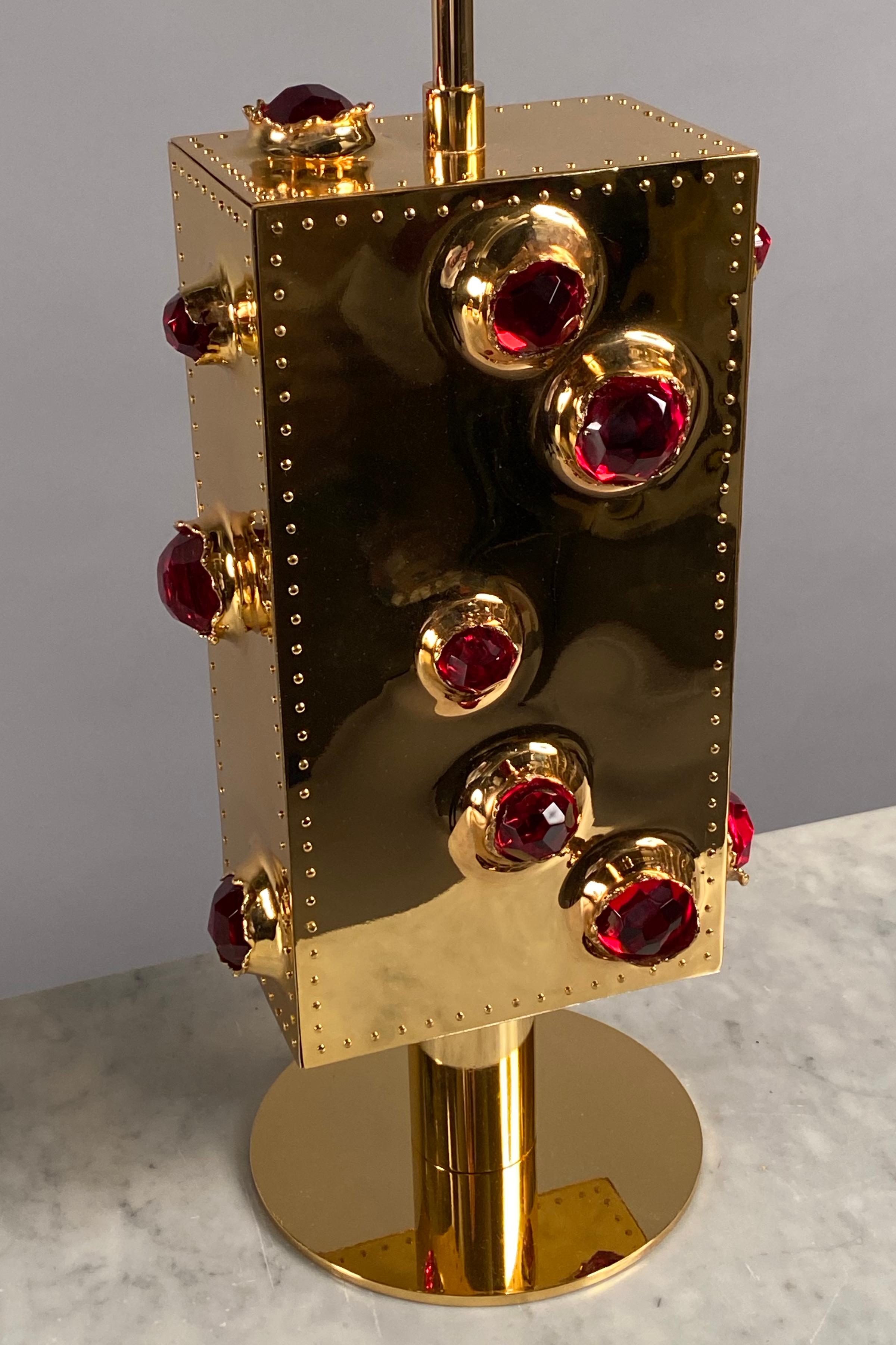 Pair of table lamps, each comprising a rectangular body clad in riveted gilded bronze plates featuring faceted ruby red glass encrustations.
Custom sizes, finishes available.