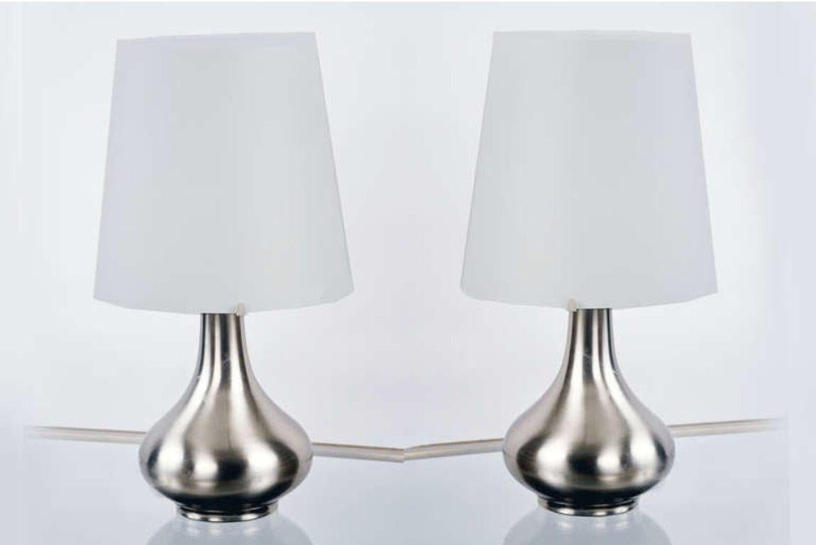 Brushed nickel table lamps with white satin glass shades. Fontana Arte model number 2344. Literature: Pierre-Emmanuel Martin-Vivier’s Max Ingrand: Du verre à la lumière, Norma Editions, model pictured on page 192.

 
