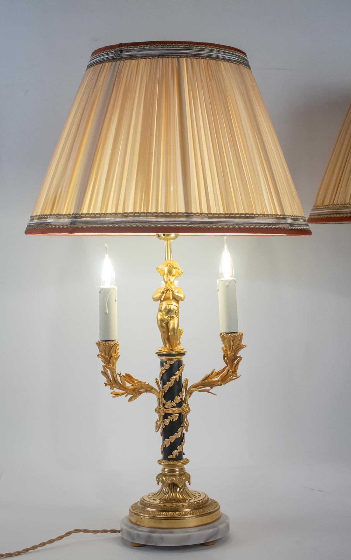Pair of lamps in love, 3 lights, gilt bronze, patinated, Louis XVI style. Marble base, large decoration.