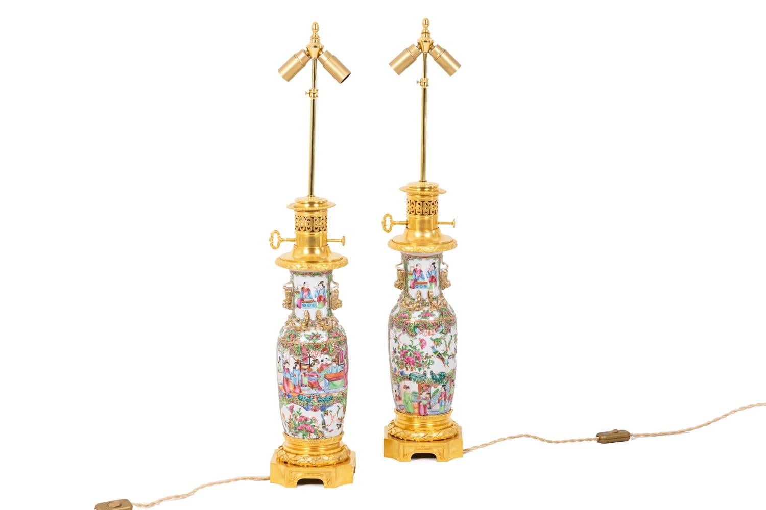 Pair of lamps in Canton porcelain and bronze. Ceramic adorned with characters, in shades of green, yellow, pink. Frame in gilded and chiseled bronze, the top presenting an openwork grid and the quadripod base of concave shape.

Travail réalisé