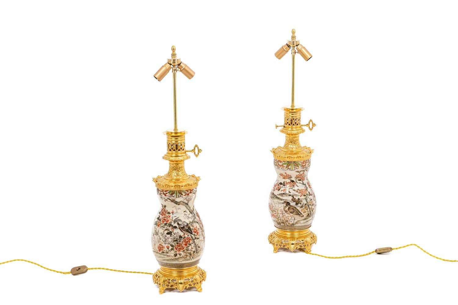 Pair of baluster-shaped lamps in Satsume earthenware with polychromed enamels highlighted with gold on white background. Decor of flowers and birds. Mount in chiseled and gilt bronze circular base in openwork.

Work realized at the end of the 19th