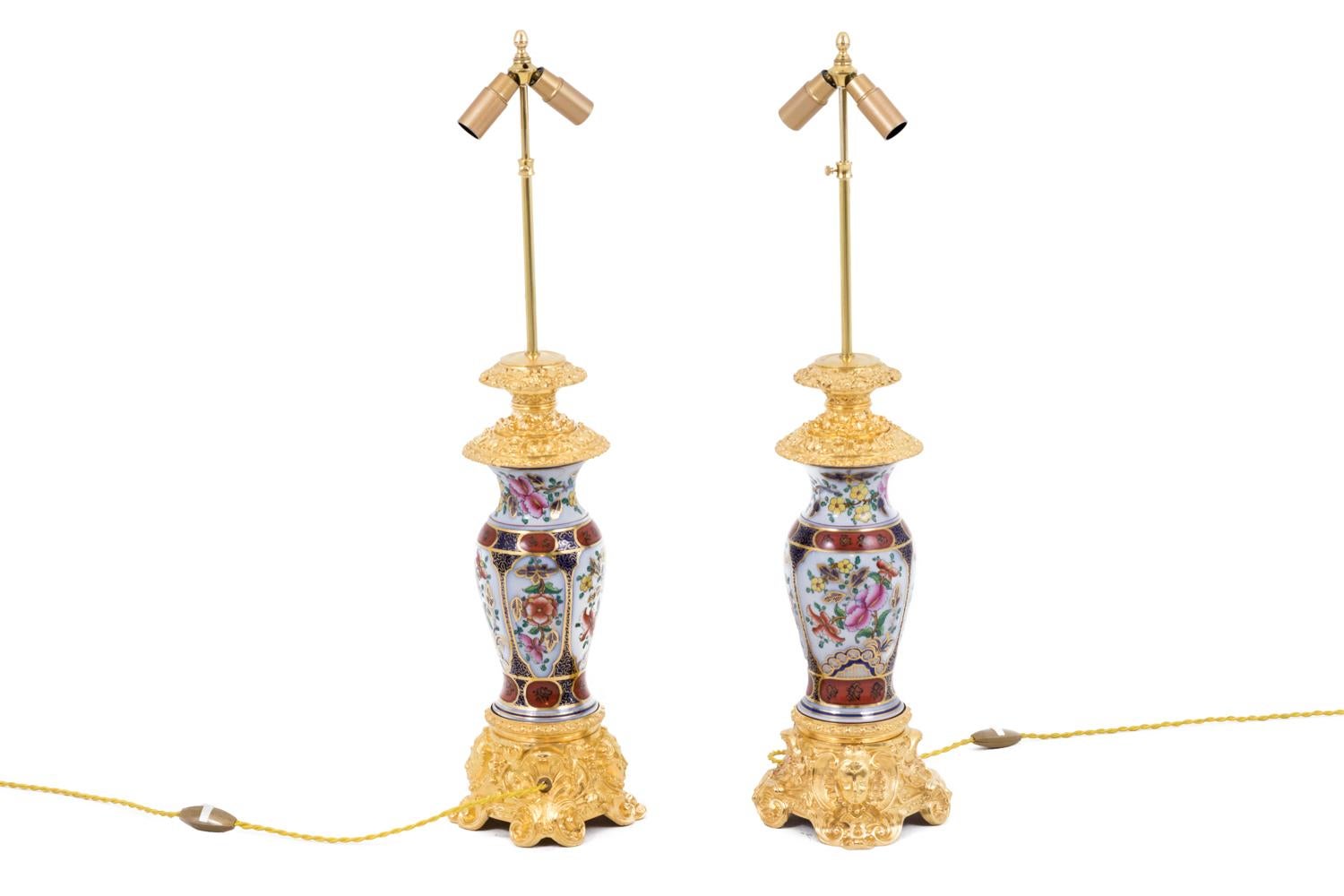 Baluster shape pair of lamps in Valentine porcelain. Decor of flowers in white background cartouches, on a cobalt blue background with gilt geometrical motifs. They are framed by two same background friezes adorned with red oval cartouches with