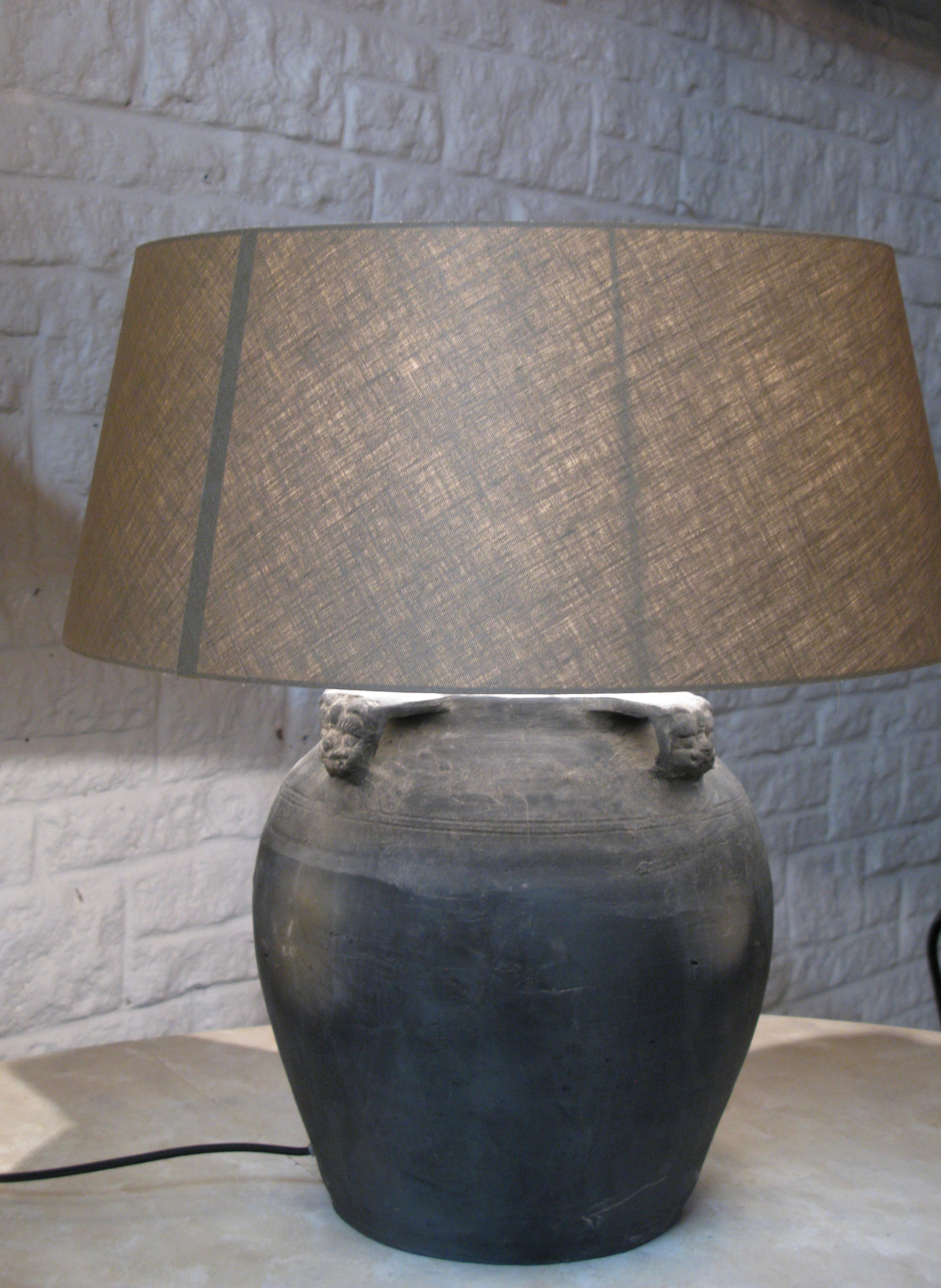 Spectacular lovely old clay pot converted into a lamp with an old grey tone linen lampshades
handles are drake head ornaments

The pot has a dark-grey /black color

Height 60 cm incl lampshade

Width 55 cm lampshade
also available with white line