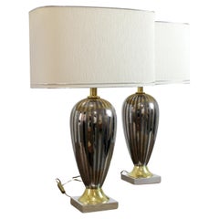 Pair of lamps with metallic-reflecting glazed ceramic stems and chromed and gild