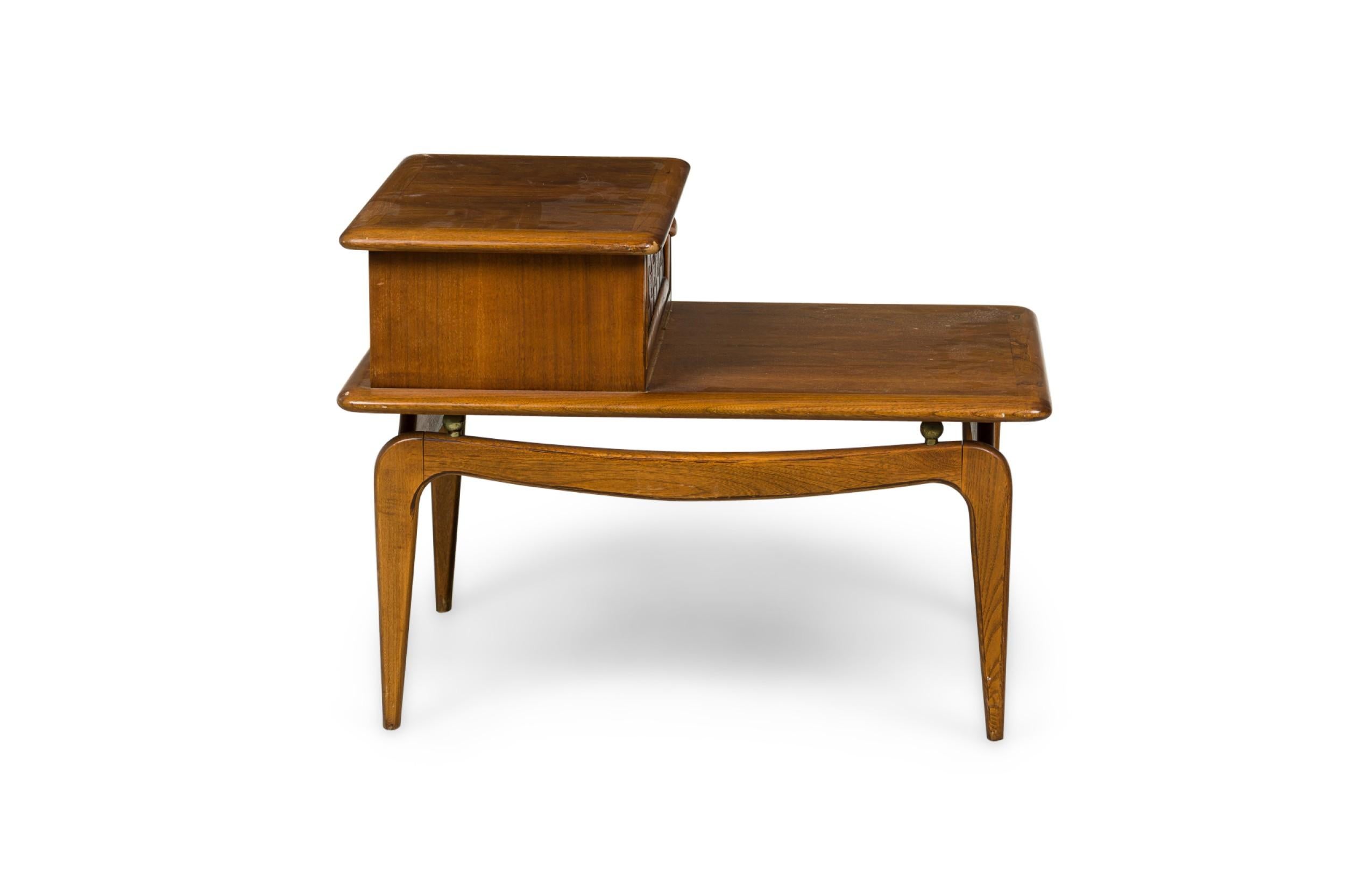 PAIR of Mid-Century American Modern (1950s) walnut 2-tier nightstands / end tables composed of a table frame with boxed cabinet and woven inlay pullout drawer, with 4 brass ball supports on curved scissor legs. (LANE ALTAVISTA) (PRICED AS PAIR)
 

