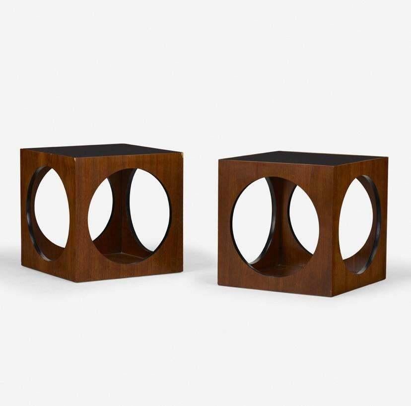 Designed and made in the 1970s by Lane, these tables are cool enough to be used as side tables, end tables, or even nightstands. Composed of a cube of walnut, each side has a perfect circle cut into it, allowing for easy access to the floor panel