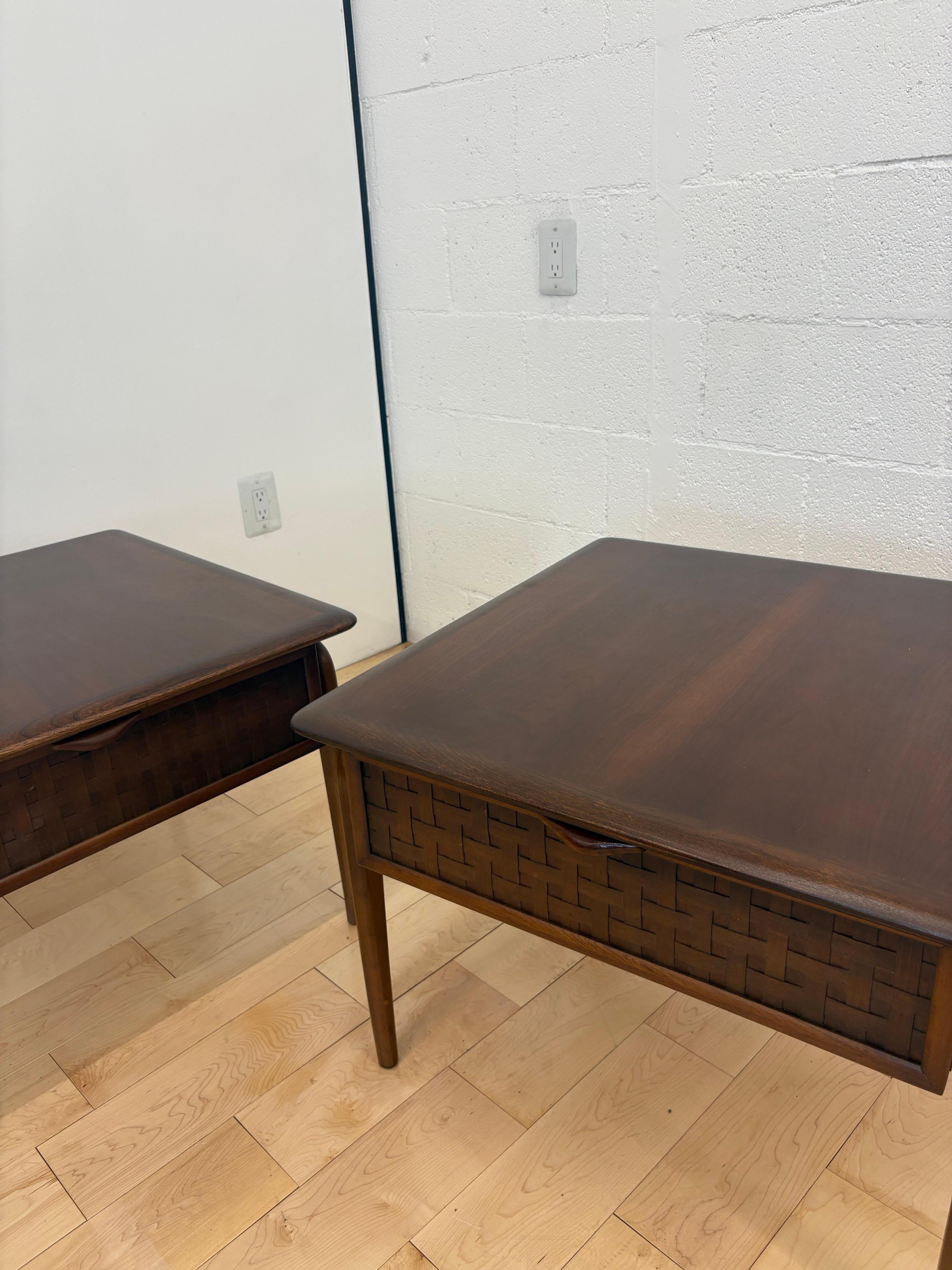 pair of 1960s mid-century modern nightstands or end tables designed by Warren Church for the acclaimed Lane Furniture “Perception” line. These vintage walnut bedside tables feature standout basketweave-patterned drawer fronts, sculpted exoskeleton