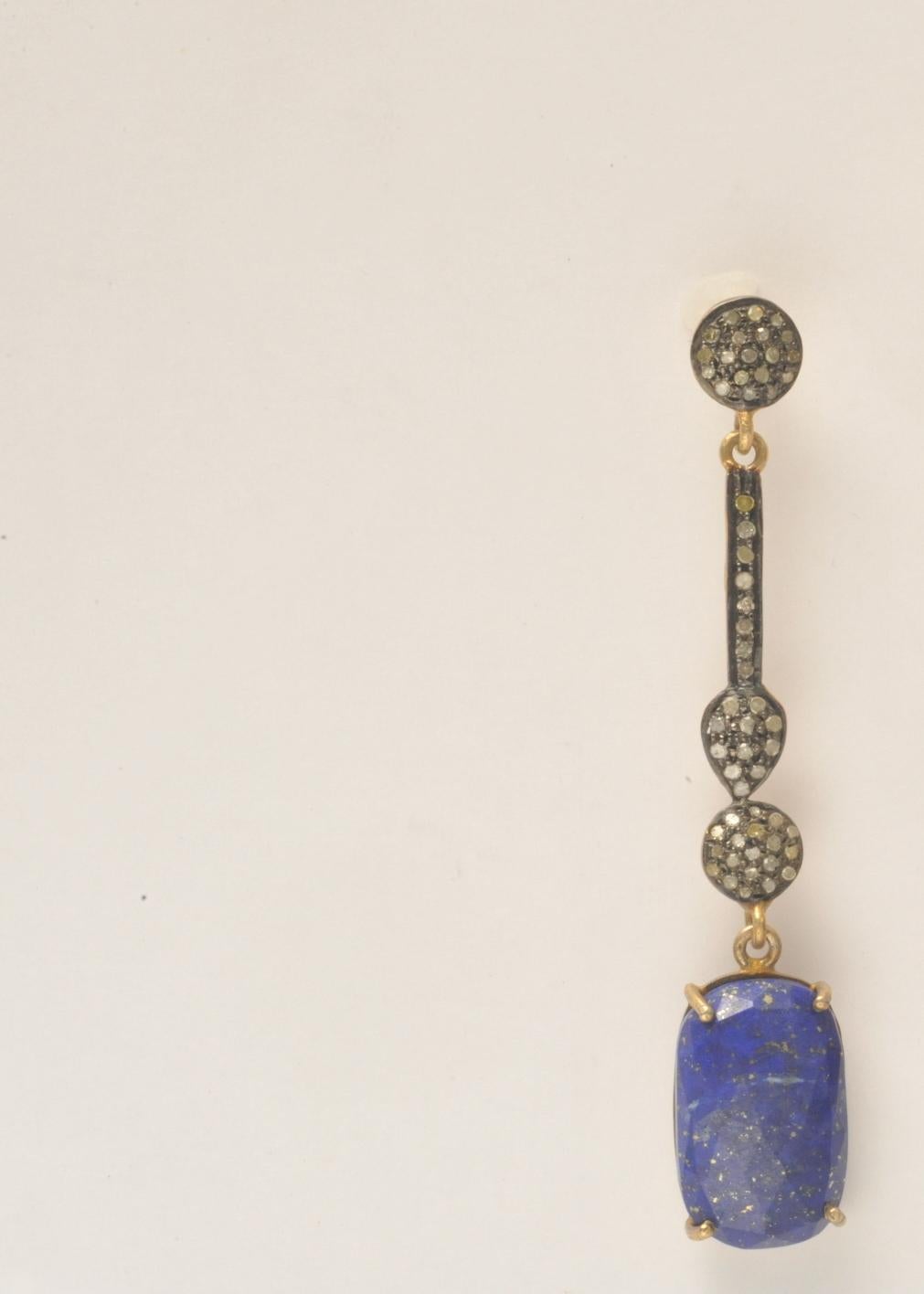 Pair of pave` set diamonds in oxidized sterling with faceted lapis lazuli.  18K gold post for pierced ears.  1.10 carats of diamonds, 24.50 carats of lapis.   Lapis stone dimensions are 7/16 inches wide x 3/4 inch long.