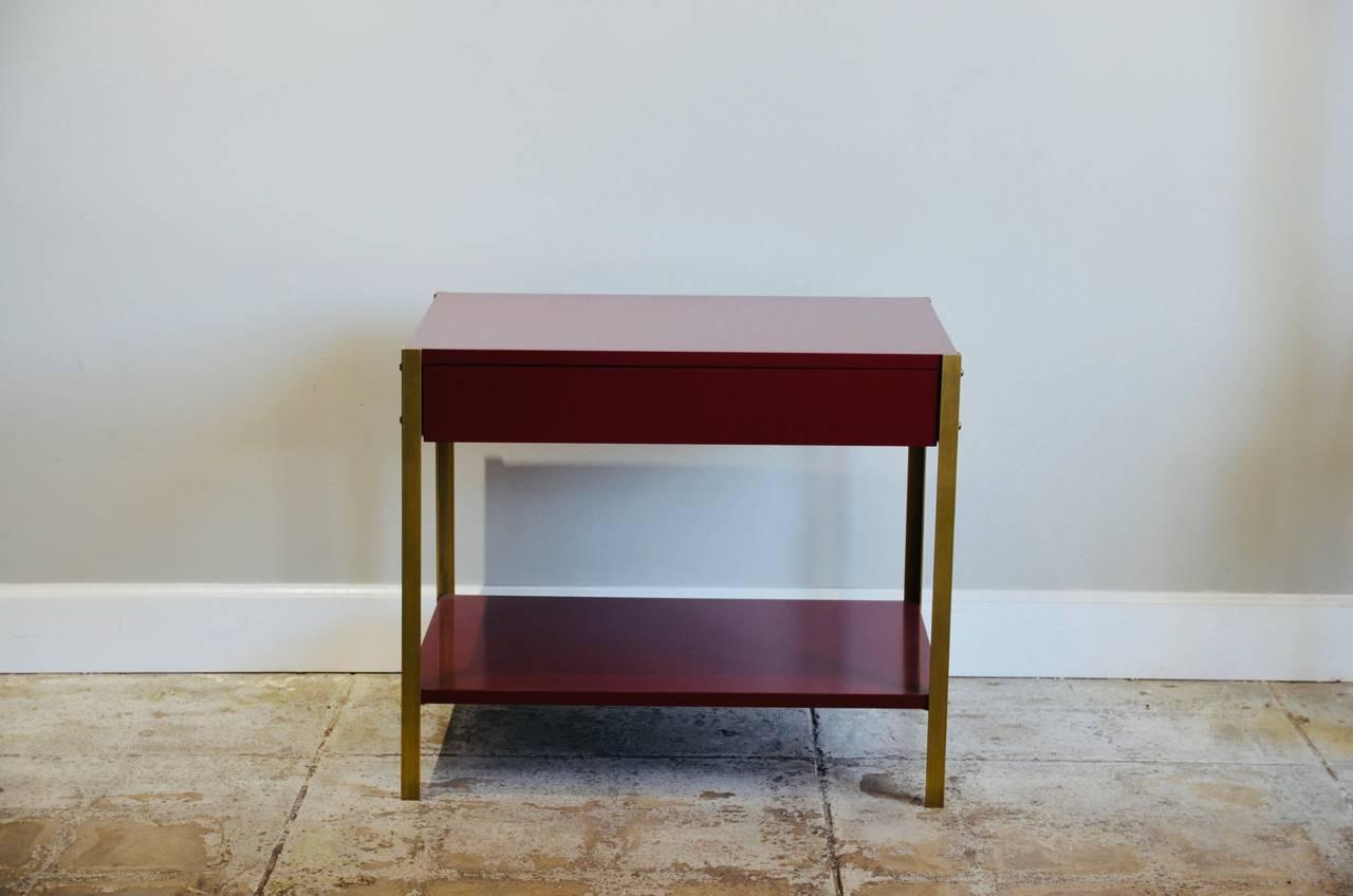 Pair of high gloss 'Laque' oxblood lacquer and brass nightstands by Design Frères.

Shelf height is 6