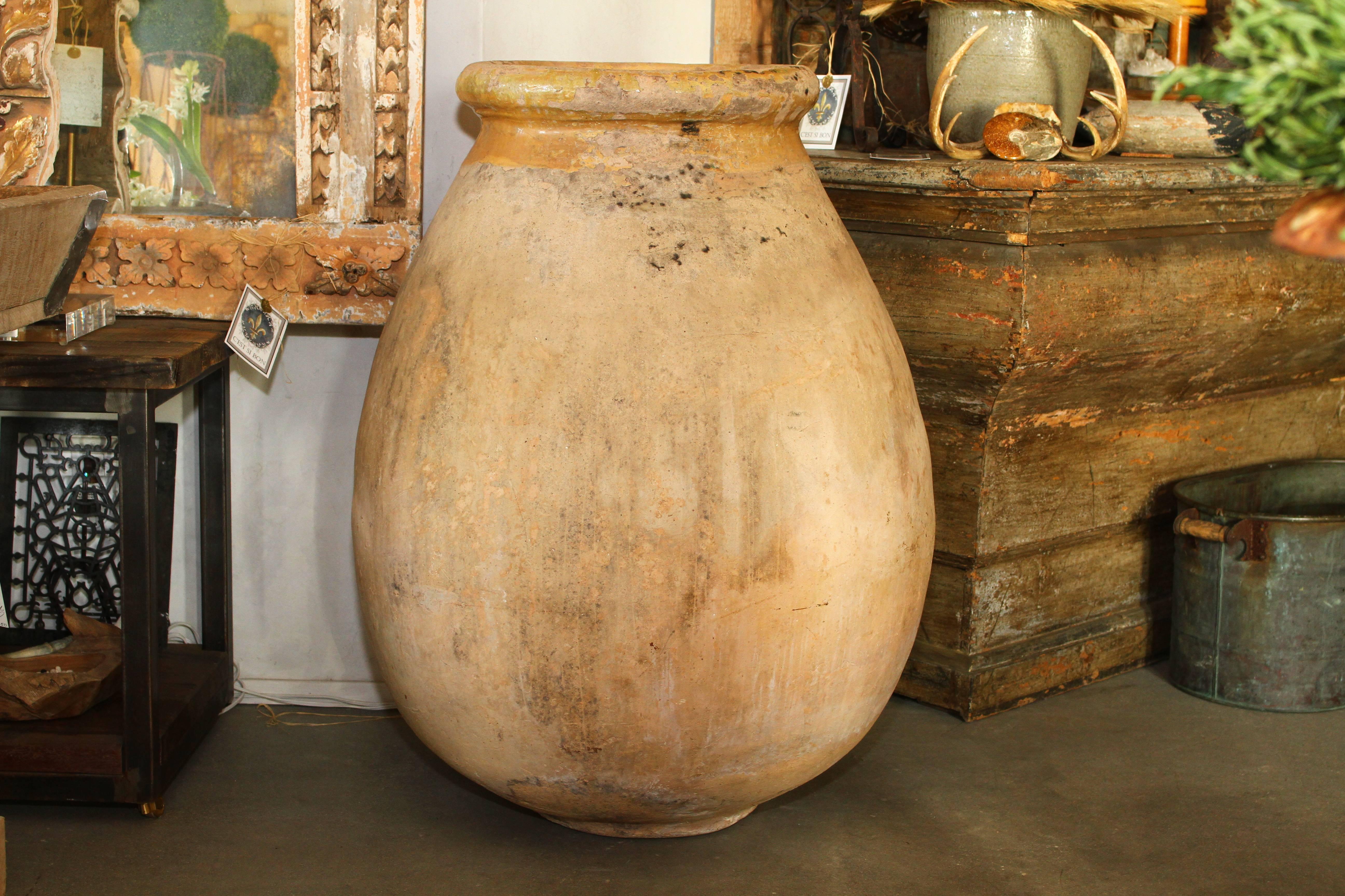 This perfectly paired antique French Provencal Biot jars date from the 1700s and in fantastic condition. Made of blonde clay terracotta with a maize yellow glazed neck, these jars were used for storage and transport of olive oil. Biot is a small