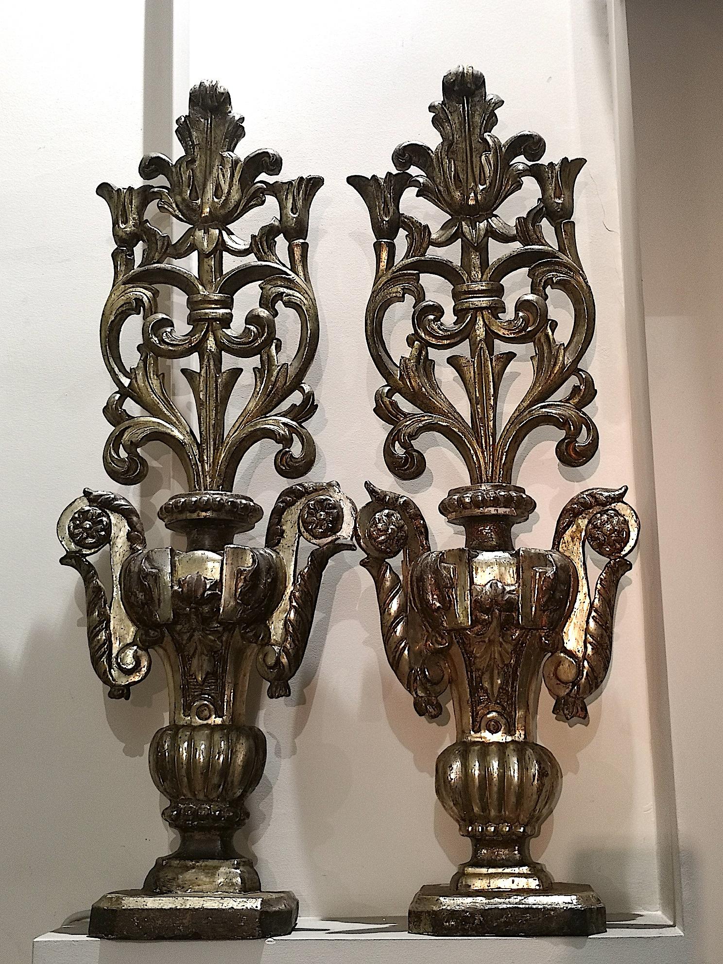 A beautiful pair of carved Italian church altar ornaments in gilt mecca silver leaf from the last quarter of the 18th century and in the Luise XVI manner. Each ornament measures 8.26 inches wide, 37.40 inches high and 5.5 inches deep. They are