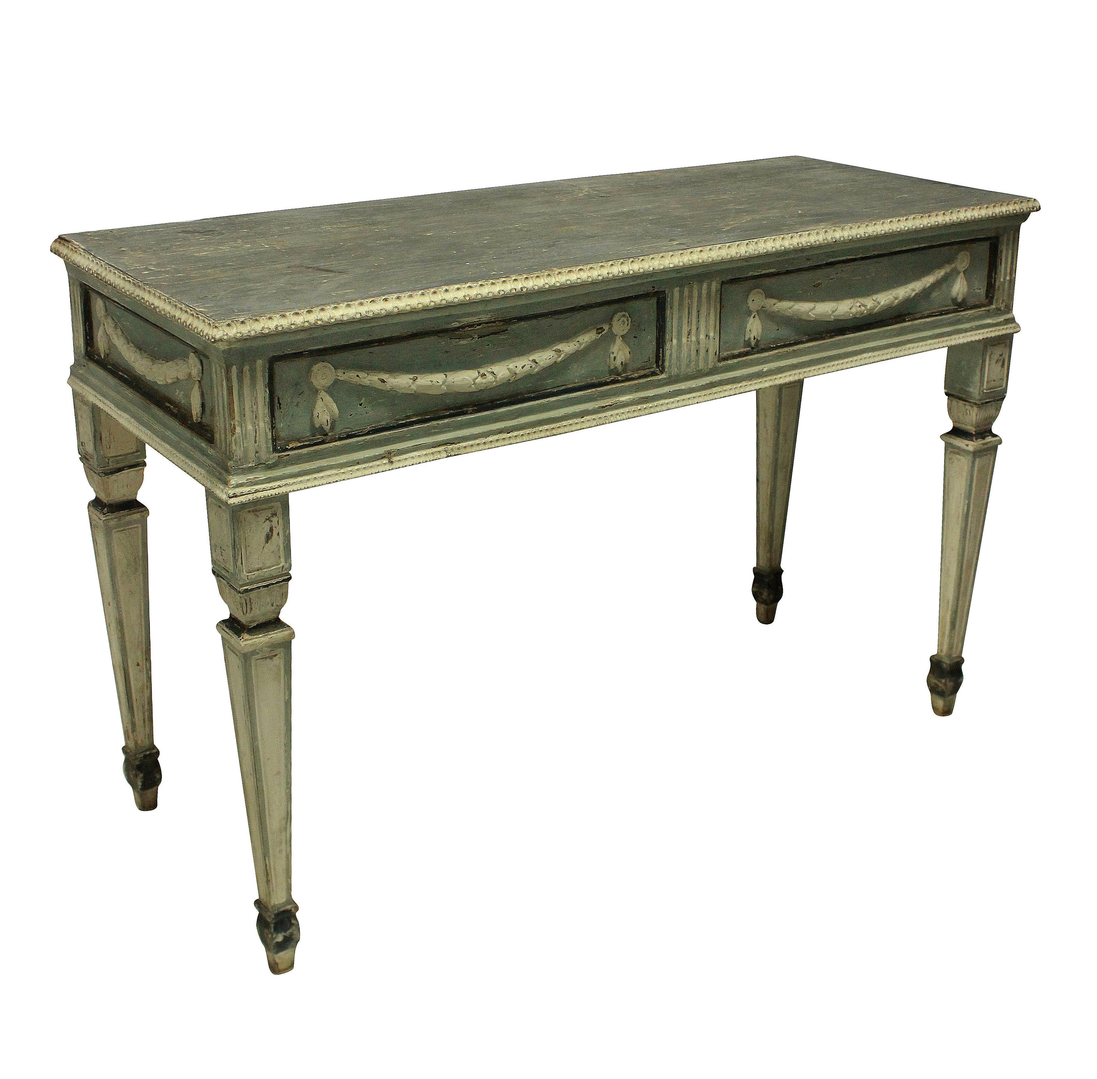A pair of large Northern Italian 18th century console tables in the neoclassical taste, with swag decoration. All of the paint is original and the colors are beautifully subtle in duck egg blues, soft white and charcoal.