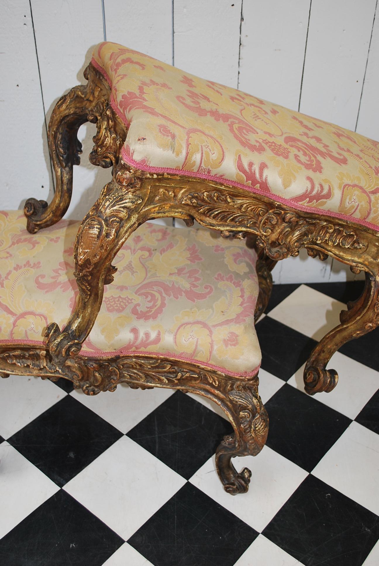 A superb pair of rare Italian carved giltwood Rococo stools, standing on cabriole legs terminating on scroll feet. Beautifully embellished in deep carving on all sides, with serpentine shaped overstuffed upholstered seats.

  