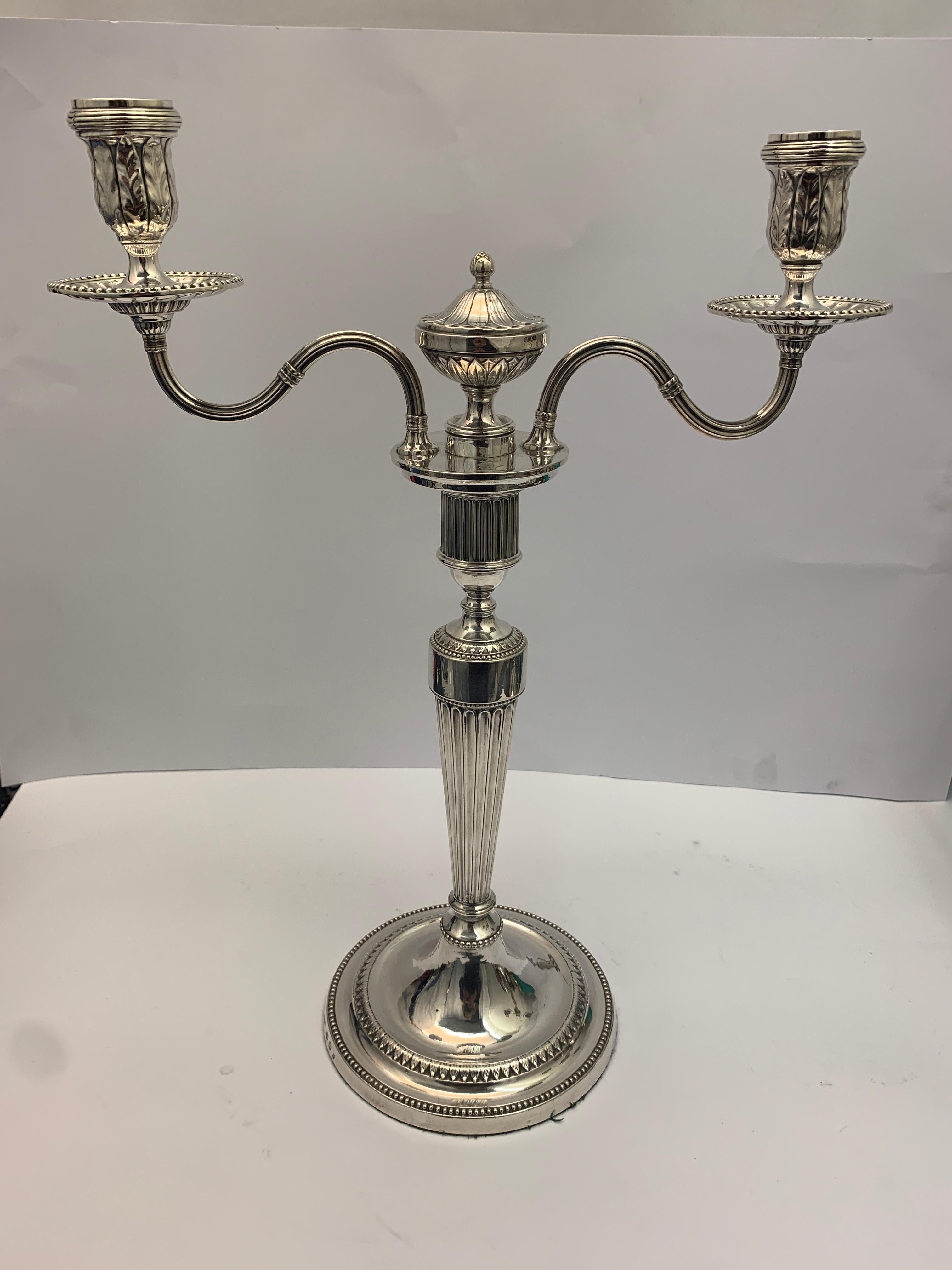 A large pair of double candlesticks dated 1780. 

Hallmarked on base.