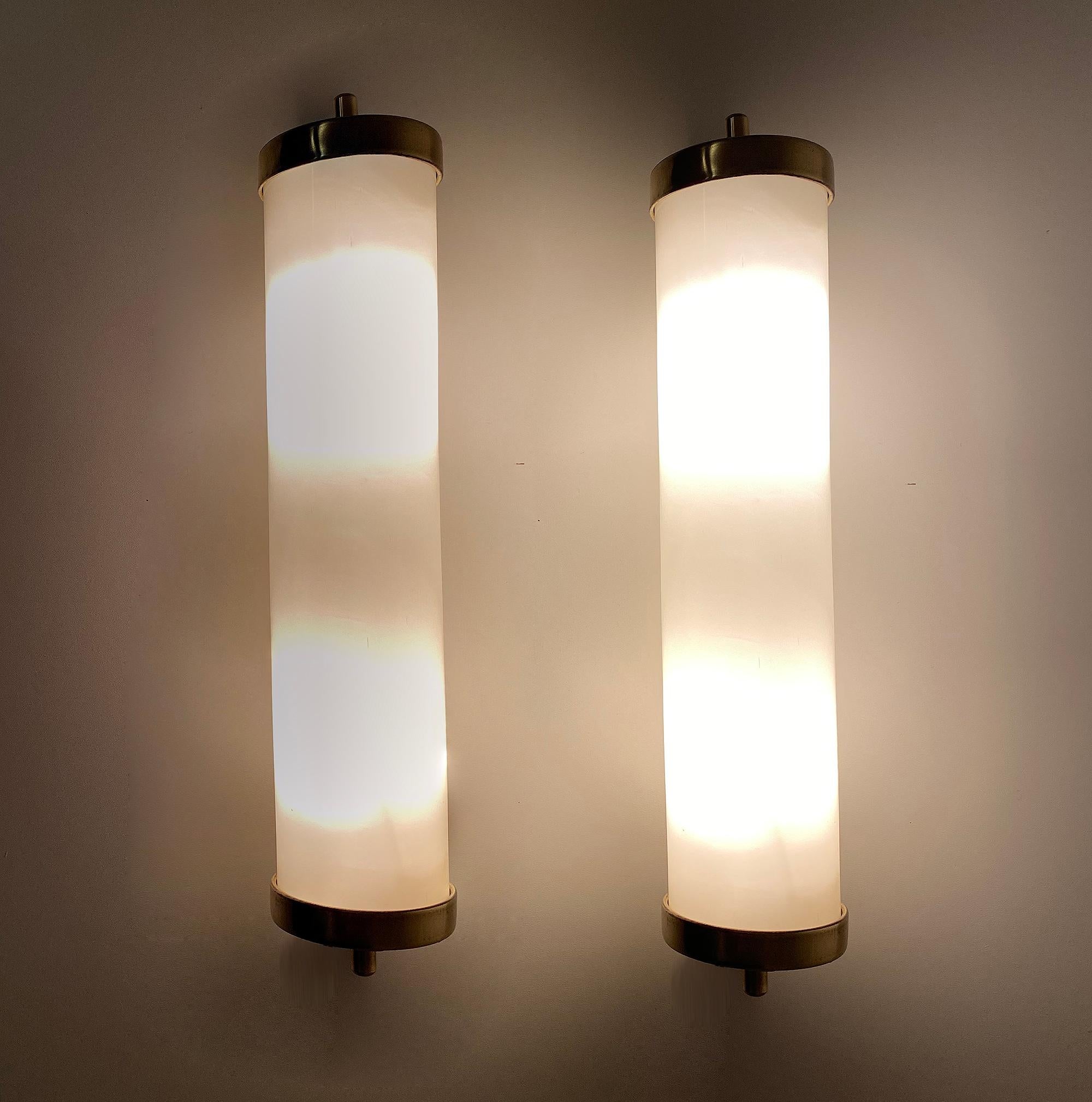 Pair of very large minimalistic design Art Deco sconces, brass base with cream white enameled caps, brass finials, milky cream white opaline glass shade, they can be used both vertically or horizontally.
Fully rewired.
Dimensions:
Height 16.93
