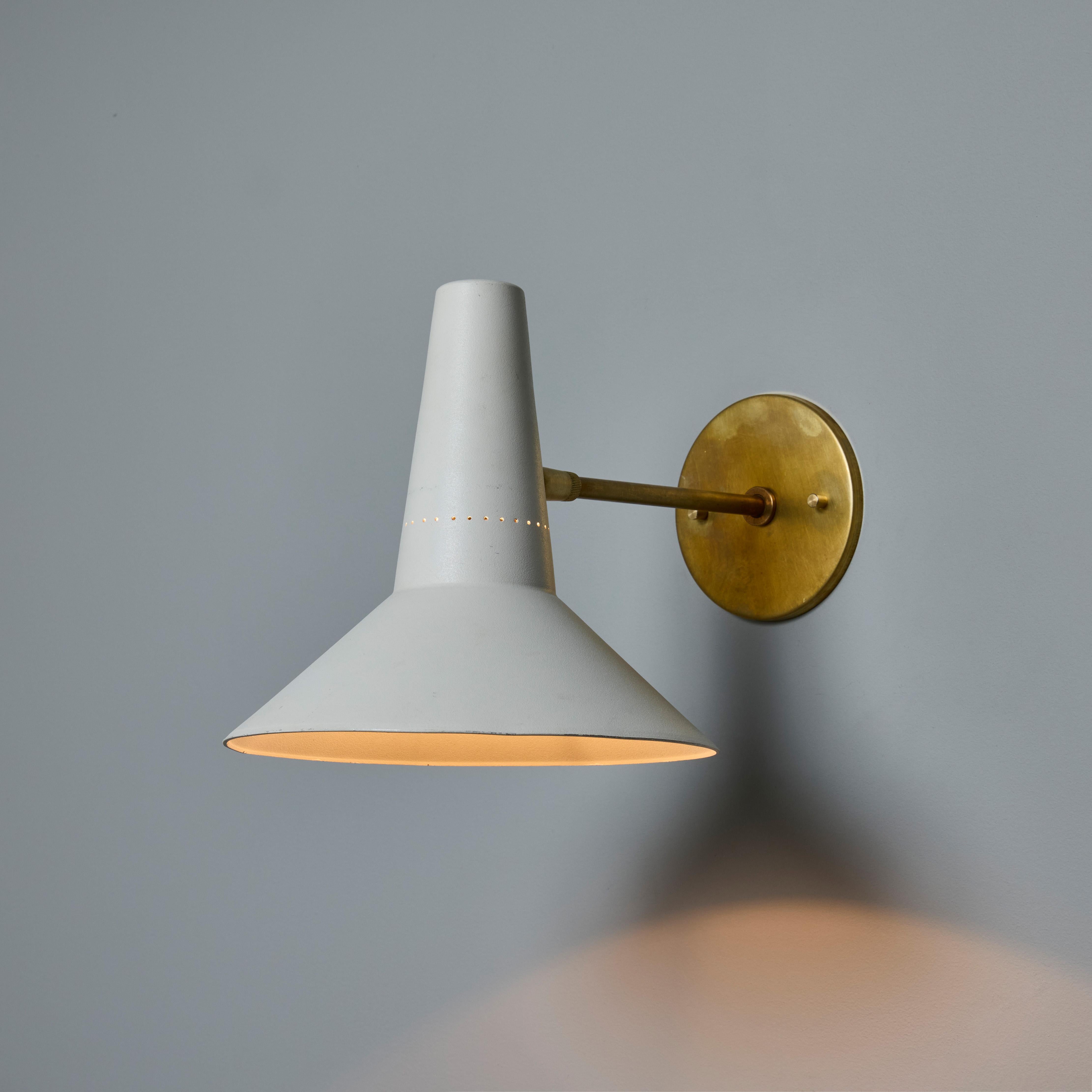 Pair of Large 1950s Giuseppe Ostuni Articulating Arm Sconces for O-Luce. 

Executed in vintage 1950s white-painted perforated shade sourced from Italy with newly fabricated custom patinated brass arm and backplate. A refined wall lamp of attractive